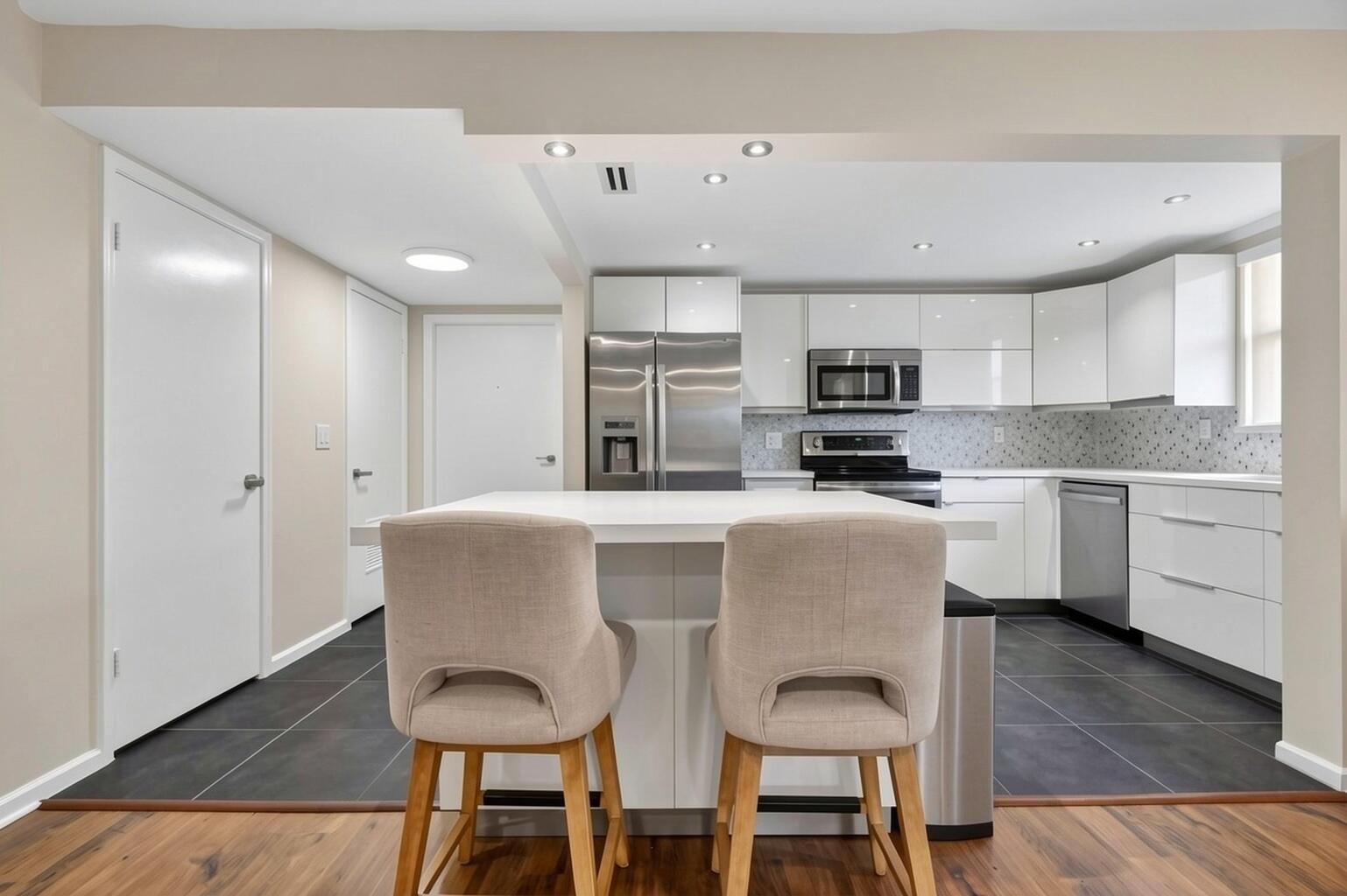 Tastefully totally renovated condo featuring an open floor plan with 2 master bedrooms, 2.5 baths, 2 walk-in closets, and a half bath, located in the gated community of Shoreside on the Intracoastal. This corner unit on the 2nd floor offers a spacious balcony and has been beautifully renovated, has brand new impact windows. The open kitchen includes white cabinetry, stainless steel appliances and an island. Wood flooring in the living areas and bedrooms, with tile in the kitchen. Stackable washer and dryer are inside the unit. Furniture negotiable. Maintenance includes water. The community offers a pool, sauna, and brand-new dock along the Intracoastal, and is conveniently close to restaurants and beaches.  Seller is open to owner financing for qualified buyers with a strong down payment.
