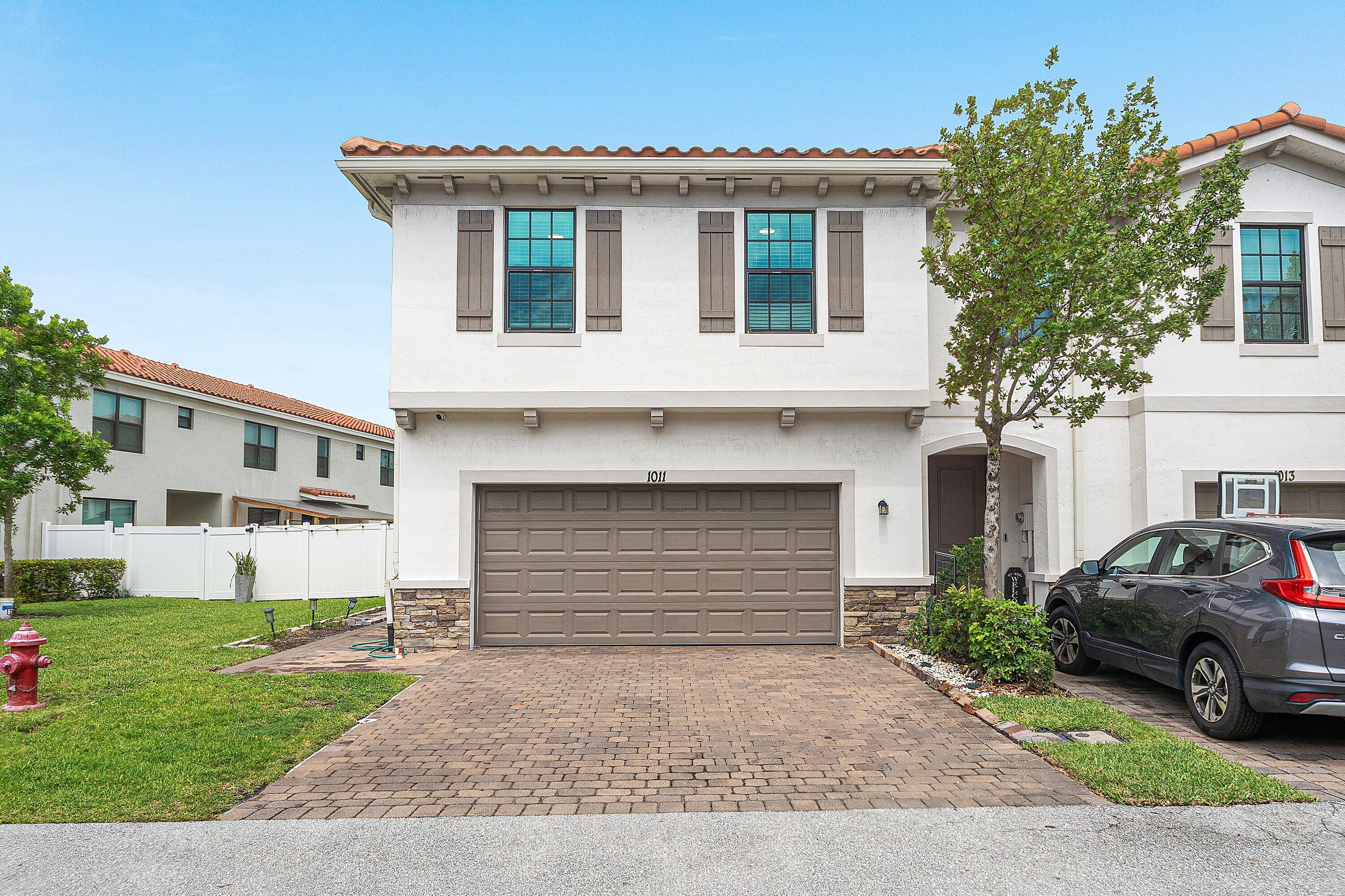 Move-in ready and beautifully updated, this 4-bedroom, 2.5-bath corner-unit townhome offers 1,743 square feet under air and sits on one of the largest lots in the community. Built in 2021, the home features an open floor plan with soaring ceilings, abundant natural light, impact windows throughout, tile flooring downstairs, and a stylish kitchen with quartz-style countertops and stainless steel appliances. A two-car garage adds everyday convenience rarely found at this price point.   Community & Amenities Located in the gated, resort-style community of Arbor Parc - Mediterranea, residents enjoy a sparkling pool, spa/hot tub, fully equipped fitness center, clubhouse, playground, scenic lakes, and roughly 1.5 miles of walking and biking trails — all within a secure, professionally managed neighborhood built by Lennar. Prime Location Positioned just off Military Trail between Blue Heron Boulevard and Northlake Boulevard, this home offers effortless access to both I-95 (via the Blue Heron Blvd and 45th Street interchanges) and Florida's Turnpike, putting the entire Palm Beach County corridor within easy reach. Palm Beach International Airport is just minutes away. Shopping and dining abound nearby, from everyday conveniences to upscale destinations like The Gardens Mall (Macy's, Nordstrom, Saks Fifth Avenue, Bloomingdale's) and the open-air shops, restaurants, and entertainment of PGA Commons and Downtown at the Gardens. Hospitals, supermarkets, and a wide range of restaurants are all close at hand. A rare combination of space, style, and location — schedule your private showing today.