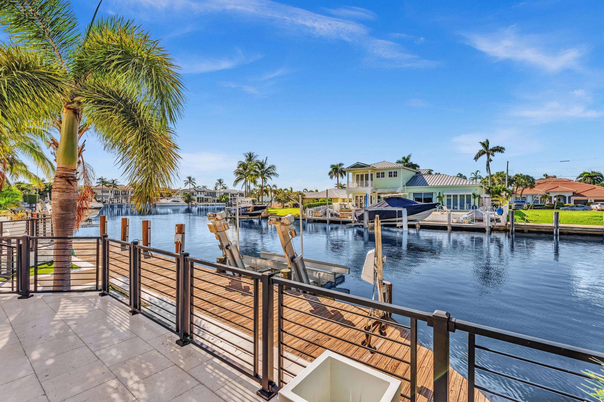 Located in the exclusive Lake Placid neighborhood of Lighthouse Point, this fully renovated deepwater residence offers 80 feet of waterfrontage and a 80 foot dock with direct ocean access and no fixed bridges. Positioned just one property off the point, the home enjoys beautiful Lake Placid views and is located only a few hundred feet from the Hillsboro Inlet, making it an exceptional opportunity for boating enthusiasts.  Completely renovated in 2021, the property features a new roof, impact glass, updated plumbing and electrical systems, a designer kitchen, renovated bathrooms, and high-end finishes throughout. The floor plan offers spacious living areas, abundant natural light, and seamless indoor-outdoor flow ideal for both everyday living and entertaining.   Thermador Kitchen Appliances, All Hurricane Impact Windows & Doors.  The waterfront outdoor space is designed to maximize the South Florida lifestyle with expansive patio areas, a resort-style setting, and tranquil water views. Located minutes from the Lighthouse Point Yacht Club, dining, shopping, and beaches, this is a turnkey waterfront offering in one of Lighthouse Point's most sought-after boating communities.