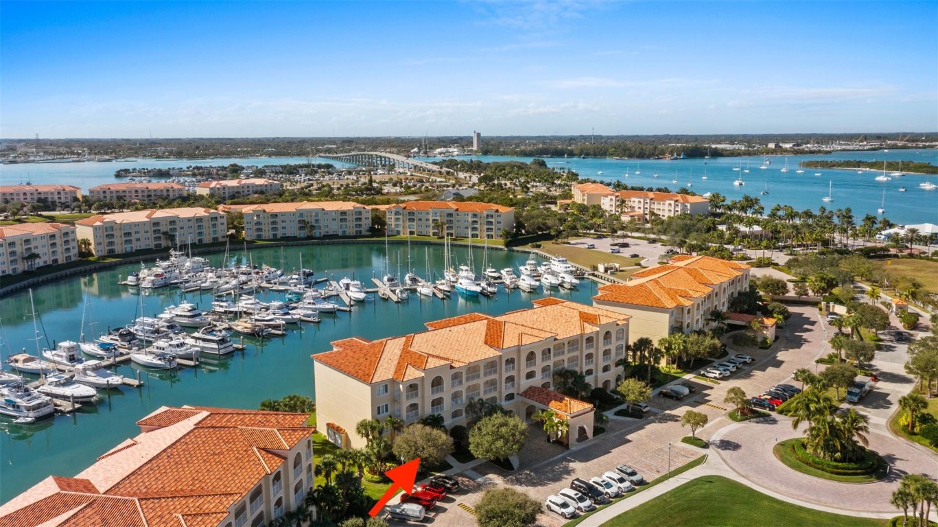 Outstanding value for this beautifully updated condo that's being sold turn-key with stylish furnishings and gorgeous marina views. So many upgrades including a custom ''Chihuly-like'' 5 foot chandelier, several one-of-a-kind fused glass pieces, wide plank luxury vinyl flooring thru-out, built-in wooden pull-outs in kitchen cabinets, stainless appliances including a Bosch dishwasher, custom picture lighting installed showcasing art, and recessed lighting added in living room. These condos were constructed w/ poured concrete walls, impact windows/doors, high ceilings, open floorplans, flex room off laundry room for office/add'l sleeping, 24-hour security guard, & outstanding amenities including club-like pool, gym, walking paths, & clubroom. Walk to the inlet, tiki bars, & d'town Ft Pierce!