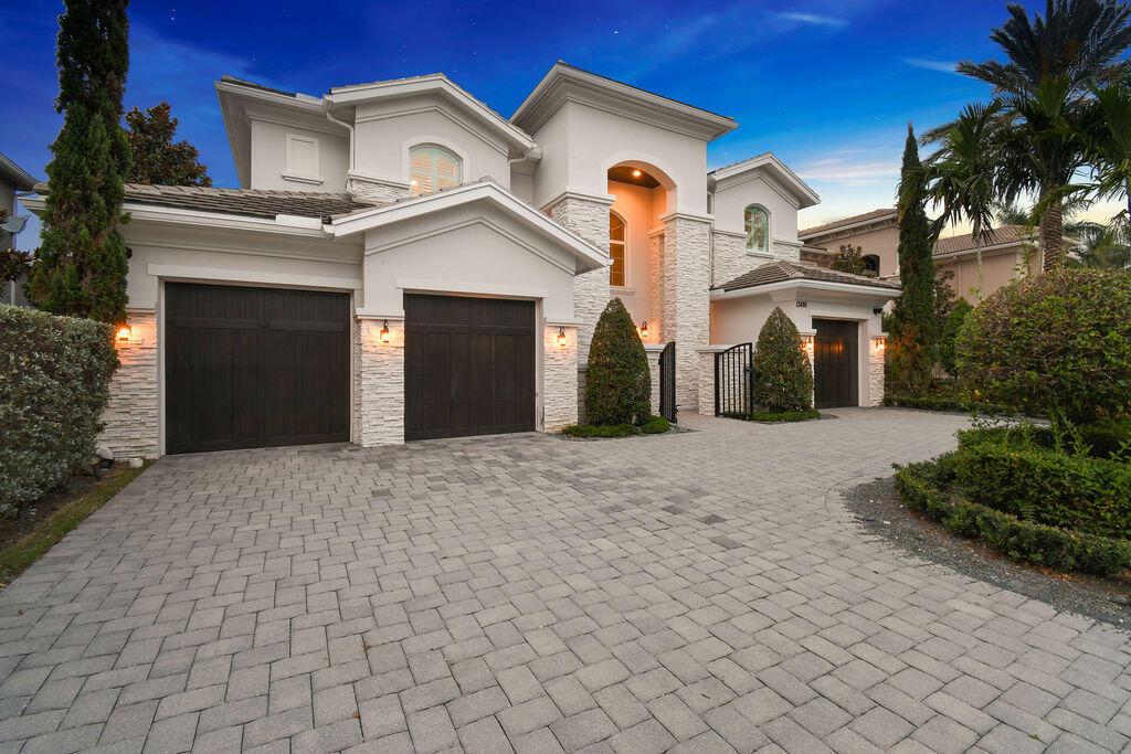 Stunning Coastal Estate on the Waterfront with Private Dock and a potentially adaptable Lift! Chic and elegant, this home was professionally designed and finished in the style of Coastal Luxury. Located in the highly coveted community of Frenchman's Harbor, this spacious floor plan boasts 5 bedrooms, a den and 5 bathrooms with over 4800 square feet under air. Situated on a serene canal just off the Intracoastal with over 70 feet of water frontage, easy ocean access, no fixed bridges and a private 45 foot dock. The oversized backyard is ideal for enjoying the ultimate Florida lifestyle, with upgraded landscaping, a saltwater pool/spa, and outdoor lanai with summer kitchen that makes entertaining a breeze. This home has the luxury of both a 2 and 1 car up to 60 ft garage, a wrap- around paver driveway and a privacy courtyard with gated front entry. This fully upgraded 2014 Toll Brother's home features a private courtyard-style entryway leading to the grand double doors. The main foyer opens up into this sprawling residence that has two separate staircases, a formal two-story living area with floor-to-ceiling windows, formal dining and a great room which encompasses the kitchen, family room and breakfast area. The kitchen features top-of-the line appliances such as a WOLF 6-burner gas range and a huge SubZero side-by-side built-in. A separate laundry room, private study/den and guest room round out the first floor. The two ground level rooms are easily accessible that share a full size bathroom and could be used as guest quarters. Upstairs, a bonus loft-style living area overlooks the formal living space. All downstairs flooring is new. Luxury custom moulding and baseboard throughout. There are three additional bedrooms and the grand master suite. The primary has his and hers walk-in closets, a private balcony and spa-style bathroom with a large walk in shower, soaker tub and separate vanities. Other home features include: 20 feet ceiling heights in foyer, crown molding and coffered ceilings, plantation shutters, impact windows, new A/C units, icynene insulation (including garage), California custom built-in closets and shelving, and fully wired smart home security system. Perfectly situated walking distance to the pristine Florida beaches and the Atlantic Ocean, and nearby PGA Boulevard's finest dining, shopping, golf courses and more!