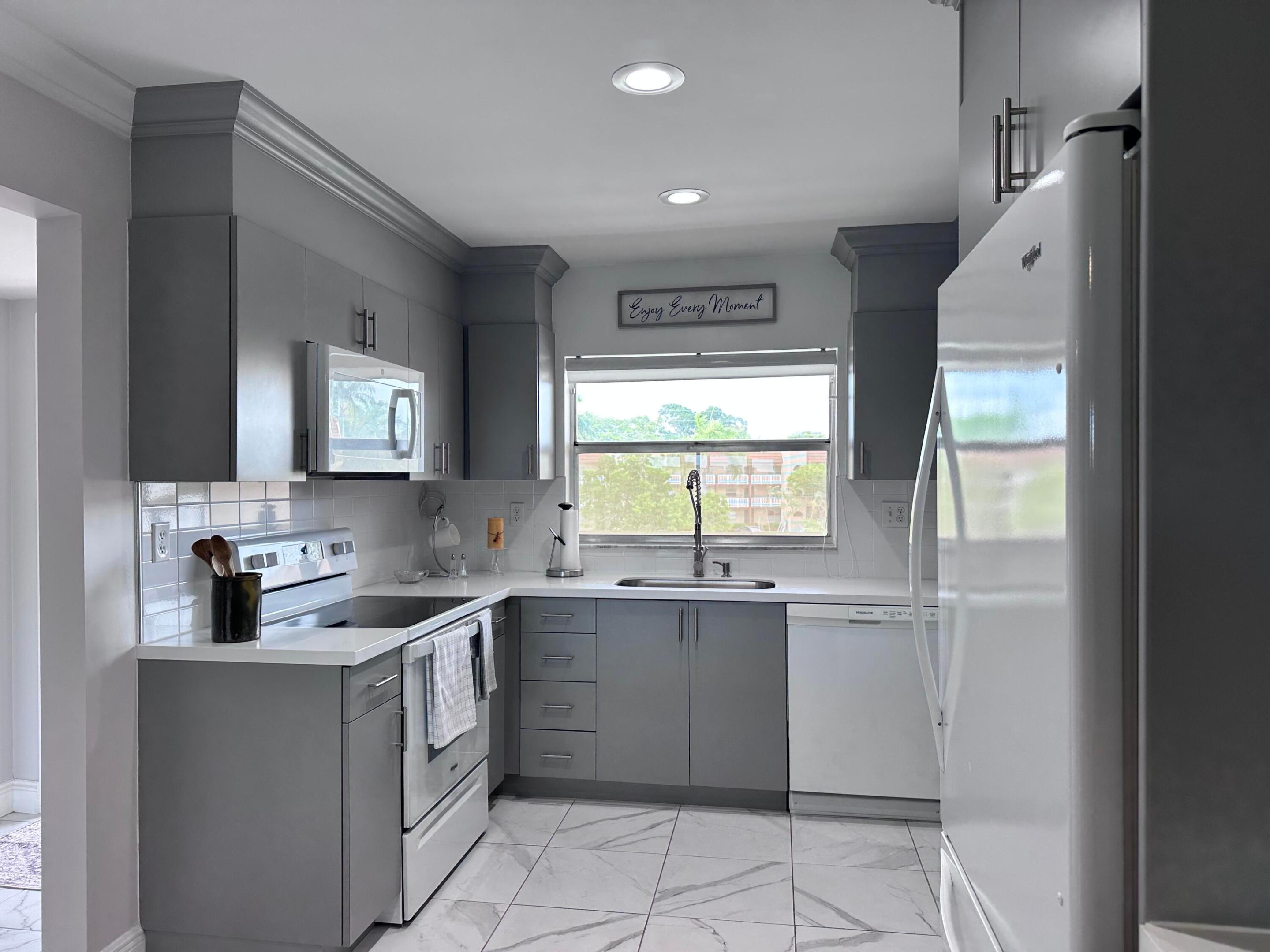 Bright and beautifully updated 2-bedroom, 2-bath condo in the desirable Sunrise Lakes 55+ community. This move-in ready home features a stunning open-concept kitchen with modern gray cabinetry, updated countertops, recessed lighting, crown molding, and new tile and laminate flooring throughout. Both bathrooms have been tastefully updated with contemporary finishes. The enclosed balcony offers tranquil golf course and lake views, perfect for relaxing year-round. Spacious bedrooms accommodate king-sized furniture with ease. Newer A/C and water heater (2021).   ASSOCIATION REQUIRES 20% DOWN ON FINANCED OFFERS, 6 MONTHS OF MAINTENANCE TO BE HELD IN ESCROW FOR 1 YEAR, AND AN INCOME OF AT LEAST $2,400.00 PER MONTH FOR EACH OCCUPANT. Low-maintenance living at its best. Enjoy resort-style living with clubhouse, indoor and outdoor pools, fitness center, golf, shuffleboard, walking paths, and numerous social activities. This well-designed 1,030-square-foot floor plan offers exceptional functionality with minimal wasted space and comfortable room sizes throughout. The enclosed balcony provides additional usable living space and can serve as a reading room, hobby area, home office, or peaceful retreat overlooking the community's lush surroundings.  Sunrise Lakes is one of the area's most established and amenity-rich active adult communities, offering residents a vibrant social atmosphere and a wide variety of recreational opportunities. Community amenities include multiple heated swimming pools, golf course access, tennis courts, billiards, card rooms, theater productions, clubs, organized activities, educational programs, group outings, and year-round events designed to foster an active lifestyle and strong sense of community.  Conveniently located near shopping, dining, medical facilities, entertainment, and major roadways, residents enjoy easy access to everything South Florida has to offer. Whether you're seeking a full-time residence or a seasonal retreat, this home offers an outstanding combination of comfort, convenience, value, and lifestyle within a financially stable and well-maintained community.