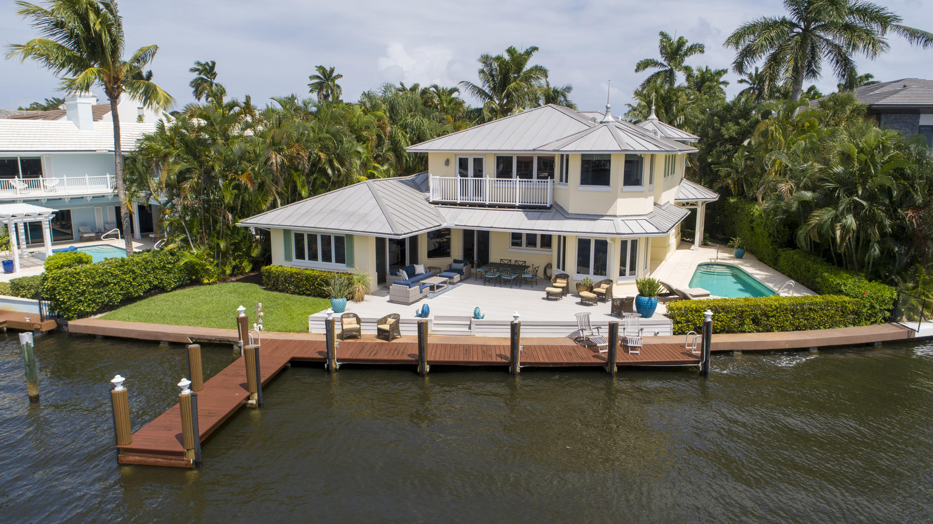 Completely renovated in 2001. Close to the beach in the desirable Seagate neighborhood, this direct Intracoastal estate fronts a wide yacht basin protected in a no-wake zone.Fronting 100± feet on the wide yacht basin, this fabulous point-like estate captures dramatic Intracoastal views seeming from the prow of a yacht.  Relaxed waterfront living and entertaining are at home in the Key West-style residence. Expansive outdoor living spaces wrap around the residence and feature a waterside lounge deck and pool patio.  The information herein is deemed reliable and subject to errors, omissions or changes without notice.  The information has been derived from architectural plans or county records. Buyer should verify all measurements. Tropical landscaping secludes the property boundaries.  In a no-wake zone, the L-shaped dock can berth a large yacht or multiple vessels.

Residence

Detailed moldings and bamboo floors complement the beautifully understated décor of this comfortable residence totaling 4,006± square feet with 3 bedrooms, 3 full baths, 2-bay garage, indoor/outdoor sound system, and impact-glass windows and exterior doors.

First Floor:  Entered from the classic front porch, the grand foyer brings in the Intracoastal view which expands through the open-plan living areas glassed with sliding doors to the waterfront deck.  Off the main living space is an inviting open family room with tongue-and-groove cedar ceiling. The family room opens to the dining room which also overlooks a tropical setting.  Adjoining a turret breakfast area lined with view-filled windows, the open gourmet kitchen includes Caesarstone counters, a wood-topped island, GE Monogram gas range and oven, Bosch dishwasher, and Vinotemp wine cooler.  Placed to either side of the foyer, 2 bedrooms include one with sitting bay.  Each has its own bath, one doubling as the cabana bath.

Second Floor:  This entire level is devoted to the privacy and luxury of the master suite, opening to a waterfront balcony with sweeping vistas.  A delightful turret office adjoins the bedroom.  Wardrobe rooms accompany the 2 baths separated by a large walk in shower. One bath includes a spa tub overlooking the front gardens.

DISCLAIMER: The written and verbal information provided including but not limited to prices, measurements, square footages, lot sizes, calculations and statistics have been obtained and conveyed from third parties such as the applicable Multiple Listing Service, public records as well as other sources. All information including that produced by the Sellers or Listing Company are subject to errors, omissions or changes without notice and should be independently verified by any prospect for the purchase of a Property.  The Sellers and Listing Company expressly disclaim any warranty or representation regarding all information.  Prospective purchasers' use of this or any written and verbal information is acknowledgement of this disclaimer and that Prospects shall perform their own due diligence.  Prospective purchasers shall not rely on any written or verbal information provided when entering a contract for sale and purchase.  Some affiliations may not be applicable to certain geographic areas. If your property is currently listed with another agent, please do not consider this a solicitation for the listing. In the event a Buyer defaults, no commission will be paid to either Broker on the Deposits retained by the Seller.  "No Commissions Paid until Title Passes."  Copyright 2019 Listing Company. All Rights Reserved.