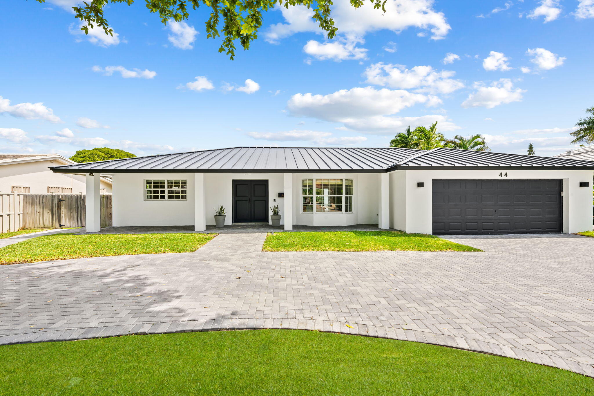 Nestled in Bermuda Riviera, this updated one-story residence showcases thoughtful improvements, light-filled living spaces, and a private backyard. The renovated kitchen features an oversized marble island, Monogram appliances, refrigerated drawers, wine refrigerator, and gas range. The open-concept living area includes a fireplace and views of the backyard and resurfaced saltwater pool (2021). Recent improvements include impact windows (2021), metal roof and skylight (2023), A/C (2025), water heater (2026), and paver driveway (2025). Dedicated laundry room, two-car garage, and convenient access to the beach, dining, shopping, and downtown Fort Lauderdale.