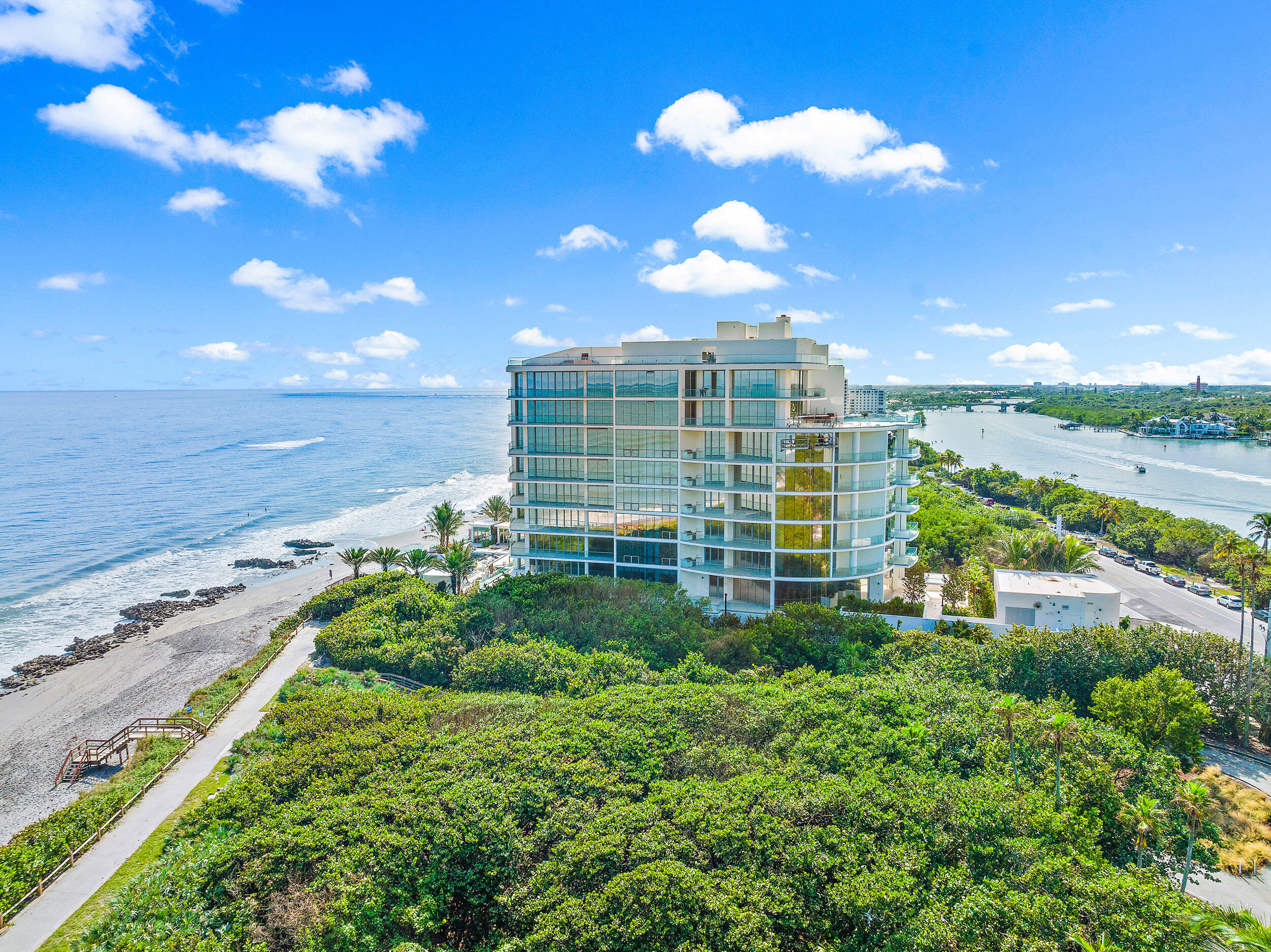 Exceptional opportunity to own this new construction residence in Jupiter Islands one-of-a-kind SeaGlass Condominium. Construction completed in 2022, being the first new condominium development in over 20+ years on Jupiter Island. Only 21 total residences offering uncompromised luxury, breathtaking views while also offering unprecedented privacy. This property is located between the ocean, Intracoastal, and lush protected landscapes. Residence 501 offers a large open floorplan with floor to ceiling glass creating a stunning ocean to Intracoastal panoramic view as you enter through the private Foyer. The ''01'' floorplan is 3 Bedrooms, 4.5 baths, with a Den, all bedrooms include ensuite baths, walk-in wardrobes and water views . Other features include three expansive terraces, a summer Kitchen, imported Italian solid core wood interior door and casings, 10' ceilings in principal living areas and bedrooms, recessed down lighting throughout interior, Imported Snaidero cabinetry with integrated task lighting, professional stainless steel ventilation hood by Snaidero, double Miele convection ovens, Miele 48'' gas rangetop, Miele refrigerator and freezer column with cabinet panel front, full height Miele wine column with glass and cabinet panel front, and two Miele dishwashers. Master bedroom has direct private terrace access, double walk-in wardrobes, individual master bathrooms with steam showers and full height frameless glass enclosures, imported marble throughout master bath, imported Italian wall-mounted vanities with designer mirrors and lighting. Other building amenities include a gated arrival, 24/7 attended two story lobby designed by Champalimaud Design, emergency generator to power residential comfort, oceanfront infinity-edge heated swimming pool, pool side sandy beach with chaise lounges, two gated stair accesses to the beach, beachside summer kitchen and outdoor viewing terrace, heated spa, full time property manager, fitness center, yoga meditation lawn, club room with catering kitchen, lounge seating and game area, outdoor social terrace with BBQ and fire pit, dedicated dog walk area and bathing station, mail & package room with keypad access, and dedicated bicycle storage.