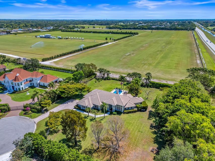 Exceptional 5/3 single-story residence with pool deck on a spacious (1.32 Acres) corner, cul-de-sac lot is now available for sale in the prestigious Equestrian community of Southfields in Wellington, off of S. Shore Blvd. & Lake Worth Rd. Renovated in 2025, the home is a short golf cart ride to all equestrian facilities. Starting from the entrance foyer, enjoy tall ceilings with arched windows in the bright, open living area with fireplace, overlooking Grand Champion Polo Fields & your private backyard pool deck. Add to that the separate family room and fully updated open kitchen with large island. The split layout of 5 oversized beds with 3 ensuite baths, walk-in closets, wood vinyl throughout. Home includes 2-car garage & semi-circular driveway. Reach out today for your private tour! ABOUT SOUTHFIELDS: one of Wellington's most prestigious equestrian communities, offering a unique blend of luxury, privacy, & direct access to the area's world-renowned horse show venues. Located within Wellington's Equestrian Preserve, the neighborhood features custom estates & equestrian properties on expansive acreage, many with private barns, riding arenas, & scenic views of polo fields.  Ideally situated just minutes from Wellington International, the Global Dressage Festival, and the National Polo Center, Southfields is a premier choice for equestrians seeking the convenience of golf-cart or hacking access to competition venues. Residents enjoy a peaceful, tree-lined setting while remaining close to fine dining, shopping, & top-rated schools.  With its spacious homesites, exceptional equestrian amenities, and prime location, Southfields is recognized as one of the most desirable luxury communities in Wellington for seasonal and year-round living.