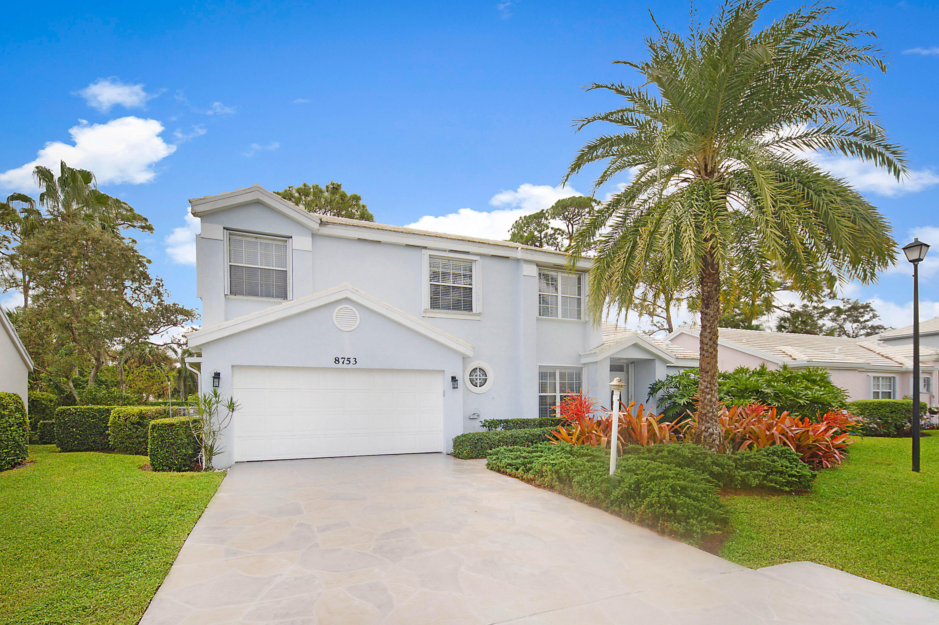 A Wonderful model home in the quaint neighborhood of North Passage in Martin County. This 4  bedroom 2.5 bath with volume ceilings has been remodeled with dark wood kitchen cabinets, wooden floors in all bedrooms, first floor has 24 by 24 inch porcelin tile.Newly stamped driveway, Impact windows complete in 2025, new AC  Unit just installed in 2026. North Passage is a gated community with a clubhouse, fitness center, pool, spa tennis court, pickleball and basketball.