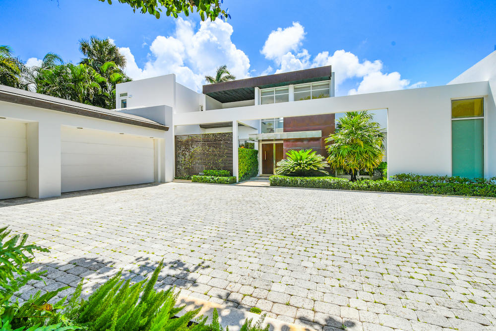 Rarely available on the North End, beautiful, architecturally designed 7,000 ± sf home boasts 118' on a high elevation with sweeping views of the Intracoastal. No expenses were spared on this spectacular, modern house designed by Mojo-Stumer Architects and built by Worth Builders. The house showcases a grand living room with double height ceilings, custom kitchen, first floor master suite, which includes his and her's bathrooms, closets and offices, and an outdoor area surrounded by lush landscaping and a pool, ideal for entertaining. The custom stone, steel, and wooden staircase floats above the foyer and takes you to the second floor with an additional 4 guest suites. Enjoy unobstructed views of the Intracoastal with full privacy from this very special home.