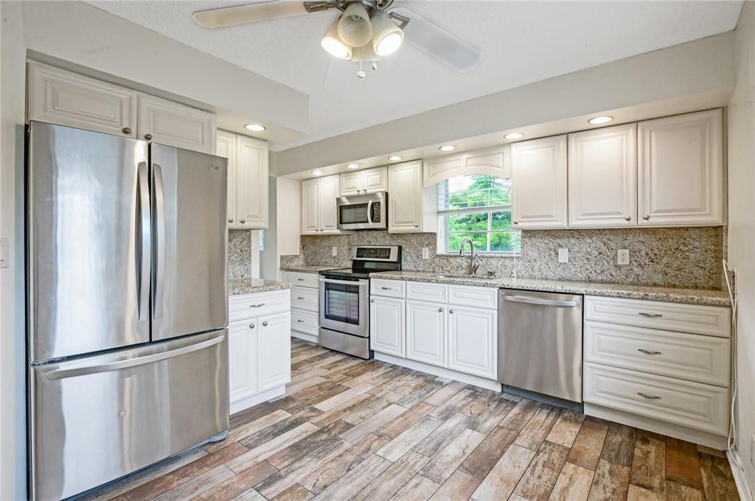 You will enjoy coming home to resort style living. One of the largest upgraded end unit over 1400 Sq Ft w/soothing water views. Foyer & kitchen have porcelain distressed wood style flooring,upgraded kitchen w/self closure wood cabinets,granite counters,state of the art S/S appliances,upgraded range w/convection oven,built-in micro,french door refrigerator,full size top of the line front loader washer/dryer,high hat lighting in kitchen,breakfast area w/ceiling fan. Entertain in formal dining room. Spacious living room w/sliding glass door to patio where you can enjoy tranquil water view. Master has sliding glass doors to patio &large walk-in closet. Guest bdrm being used as office. Virtual Staging. Amenities Galore & Golf Course. Assn says 55+ requires 20% down no rental first 2 yrs No membership required Golf Course Community, State of the art Theater with live shows & movies, Recreation Facilities with main pool, card room, library, billiards, arts & crafts, full size gym, tennis courts,basketball courts,  shuffleboard, pickle ball, walking and bike hikes, 3 ballrooms, two 24/7 gated community.  Courtesy bus service