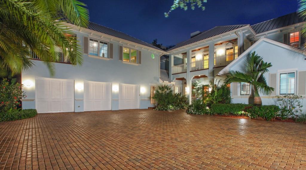 Beautiful, British West Indies estate home situated on a 2/3 acre, blue water home site with unbelievable views of the Loxahatchee River, spacious backyard and white sugar sand beach. Features of this waterfront paradise include formal living & dining rooms and a chef's kitchen (which overlooks the spacious family room) equipped with a large prep island, granite countertops & top-of-the-line stainless steel appliances. There are 4 bedrooms within the main home, all with private baths, 2 office/dens & gym, plus 1BR/1BA guest quarters with a kitchen. Quality features include hardwood floors, custom volume ceilings, detailed moldings,     hurricane impact windows & doors and a standing seem metal roof. The spacious, covered patio includes a summer kitchen and overlooks the pool and river!