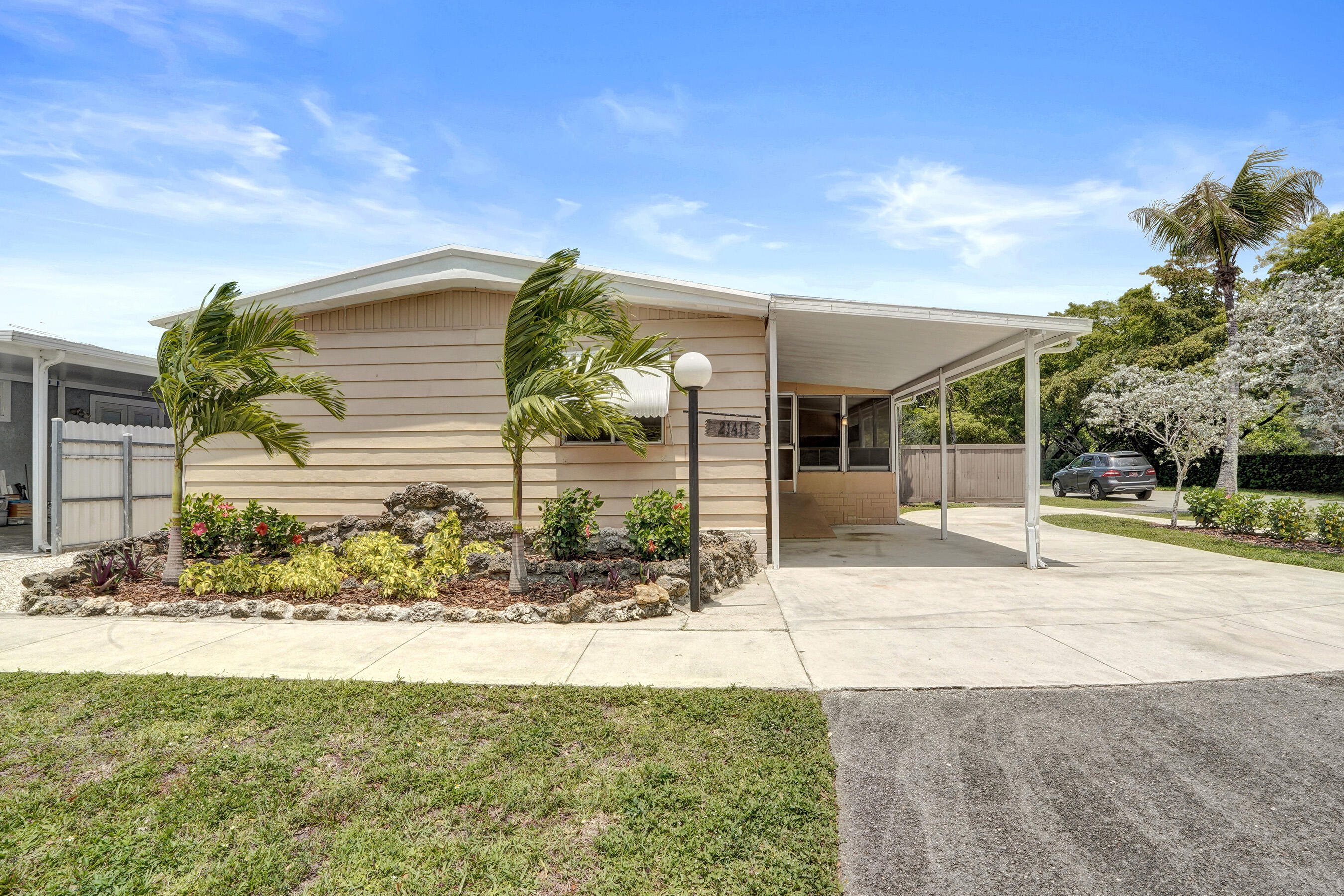 3BR/2BA manufactured home offering approximately 1,585 sq ft of living space on a generously sized lot with the advantage of land ownership (no lot rent). Brand new floors throughout the house! Other features include spacious Florida room providing additional flexible living space ideal for entertaining; large fenced in yard with room for outdoor living or future enhancements; plenty of parking; durable metal roof for enhanced longevity and low maintenance.  Freshly landscaped. A great neighborhood with community pool, playground, and covered areas for larger gatherings. 3/2 corner lot, land is owned.
