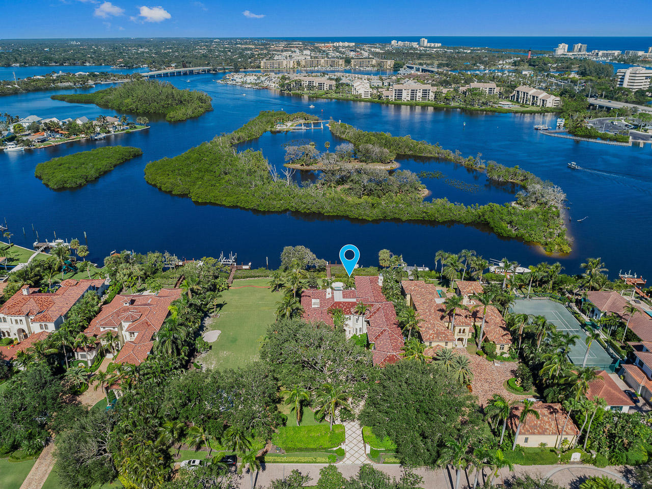 Waterfront ''Villa Paradiso''.. exquisite views, architecture & amenities to entertain. 6 Luxurious Suites! A Starlit Theater! A club room with billiards! A Gym/Spa/Sauna! A Gentleman's Pub Room with office. A poolside lanai and roam for a 70 ft. yacht! All just minutes to the Jupiter Inlet and the finest shopping and dining. Adjacent lot also available RX-10381989.