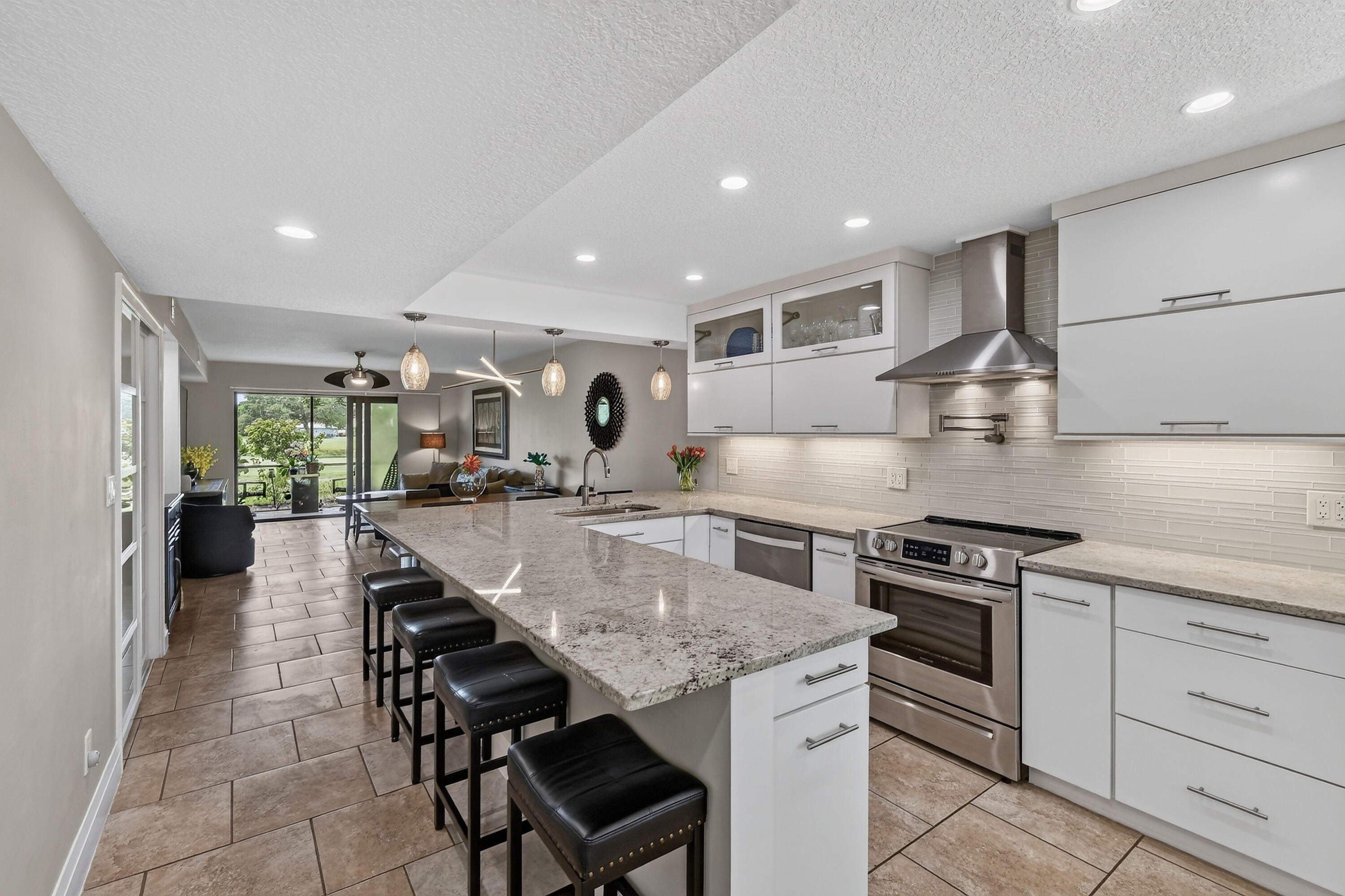 Welcome to this completely renovated LAKEFRONT first floor end unit located between 5th and 6th holes at The Golf Club of Jupiter. This is perfect Jupiter living as you watch or play golf by day and enjoy the sunset over the lake in the evening. This home has a  very nice and bright open floor plan with split bedrooms for privacy. The beautiful white kitchen has all soft close cabinets/drawers and has granite countertops. Entertaining your friends and family will be delightful centered around your large kitchen island. You will have peace of mind with all IMPACT GLASS, an electric hurricane screen for your back patio, and a  2024 ROOF! Enjoy the privacy and extra natural light of an end unit and the convenience of first-floor living. Keystone is a sought after community surrounded by  restaurants, shopping, Jupiter/Juno Beach, and within 15 miles of Palm Beach International Airport. Make your appointment today!