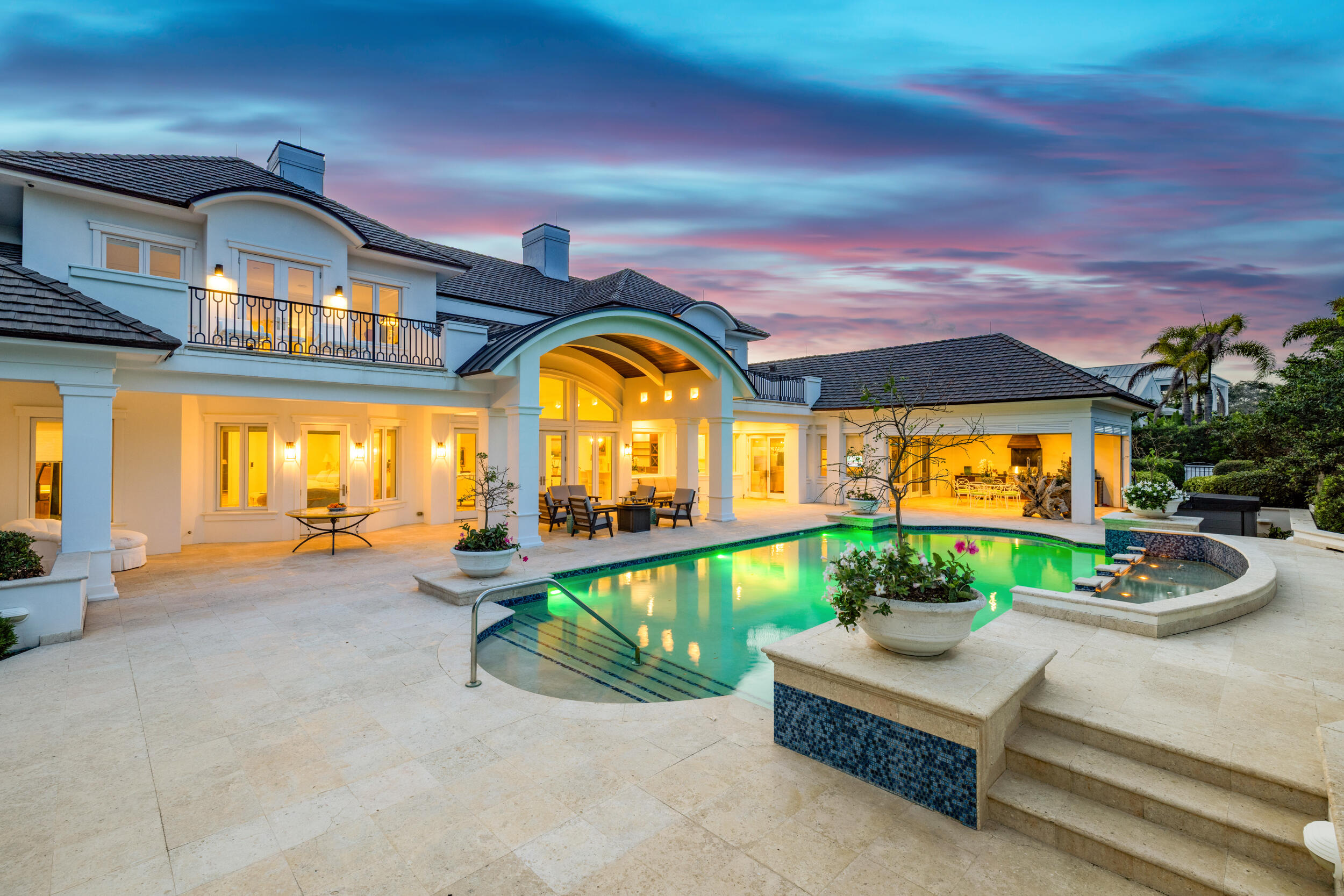 Welcome to 17965 SE Village Circle located inside the gates of Jupiter Hills. Set on over 1/2 acre overlooking the 3rd hole of the Village Course, this elegant golf estate combines timeless architecture with modern upgrades. This home offers 5 bedrooms, including 2 primary suites, 6 full baths, 2 half baths, a private office, in-law suite, and expansive living spaces designed for effortless indoor-outdoor entertaining. The chef's kitchen features Sub-Zero and Wolf appliances, updated cabinetry and countertops. Additional improvements include impact glass, a newer roof, outdoor loggia and other exterior finishes. The primary suite boasts dual baths, generous dressing areas & closets, and stunning golf course views. An exceptional opportunity in one of Florida's premier golf communities!