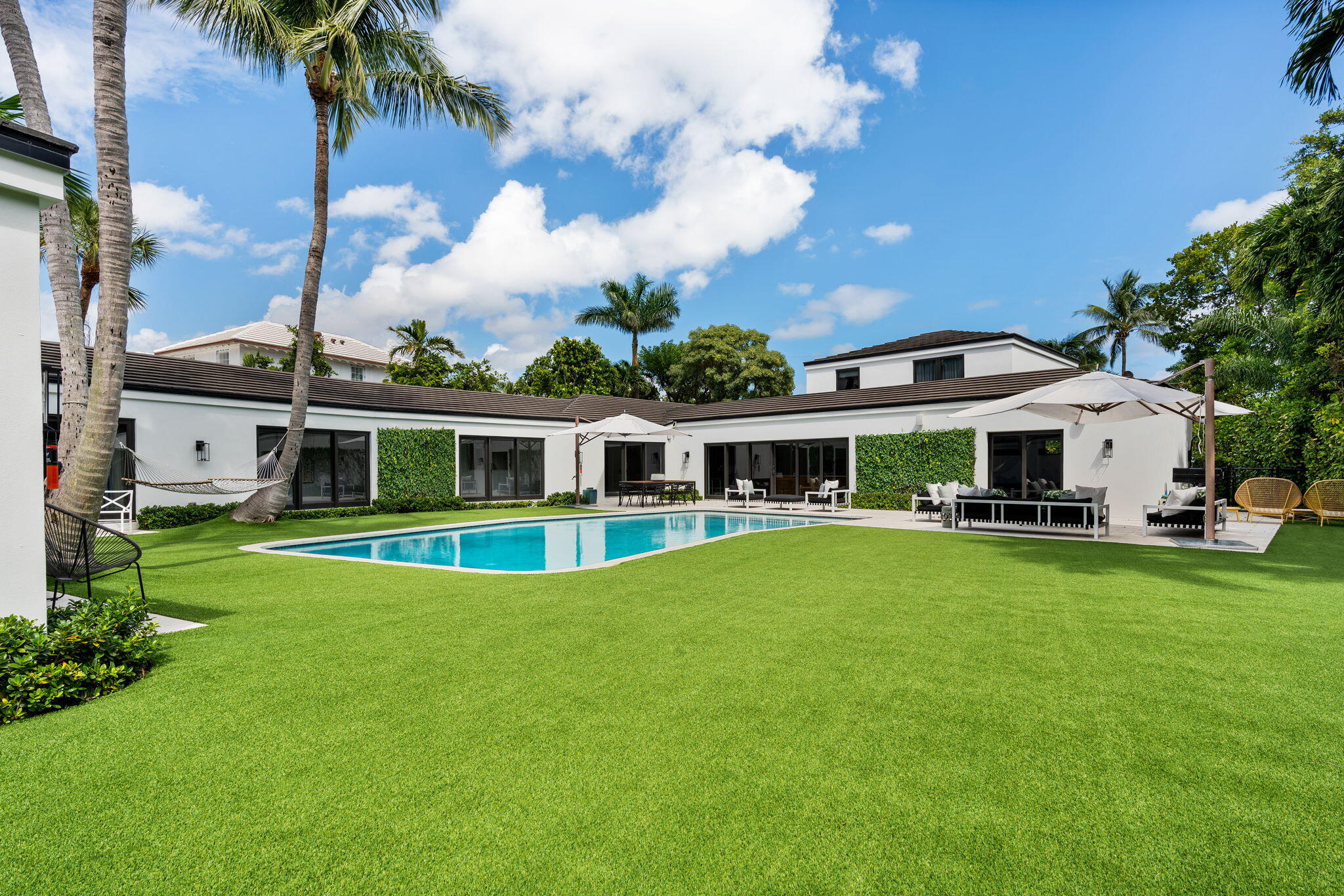 Prepare to be captivated by this thoughtfully remodeled 5-bedroom, 5.2-bathroom Mid-Century Modern residence. Nestled on a generous 17,800 +/- square foot lot in the highly sought-after North End of Palm Beach. An Art Collector's dream with an abundance of walls to showcase your prized pieces.
 
The heart of the home is undoubtedly its gourmet chef's kitchen. Boasting an oversized island and top-of-the-line appliances, it seamlessly integrates with options for al fresco dining.
 
Enter the Owner's wing, a sanctuary that encompasses a serene sitting room, a luxurious primary bathroom, and twin walk-in closets. Every aspect exudes sophistication.
 
But there's more to explore in this remarkable home. You'll discover a cozy library, a wet bar for entertaining, and a versatile second floor above the garage. Currently being used as a gym, it has the potential to double as a guest suite.
 
Experience a home that not only embraces your love for art but also offers timeless style and an exceptional living experience.