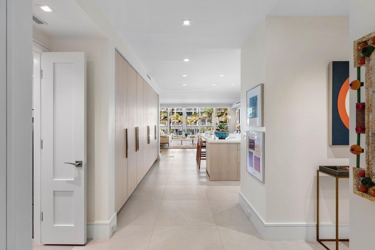 Experience the pinnacle of luxury in this beautifully renovated 2-bedroom, 2.5-bath lanai apartment within a premier Palm Beach oceanfront condominium. This residence features a sleek, open design with custom built-ins, exquisite lighting, an open chef's kitchen. The master suite offers expansive storage, an elegant lounge & a stunning bath. A split-bedroom plan ensures privacy. Enjoy breathtaking ocean views & a light, bright atmosphere. A convenient staircase leads directly from the balcony to the new pool area & beach. Located in the secure, gated Sloan's Curve community, you'll have access to 6 Har-Tru tennis courts, a pro shop, new fitness rooms, 2-car garage parking, 2 Storage Lockers, 24/7 door personnel & on-site management. Experience a lifestyle of unparalleled luxury & services.