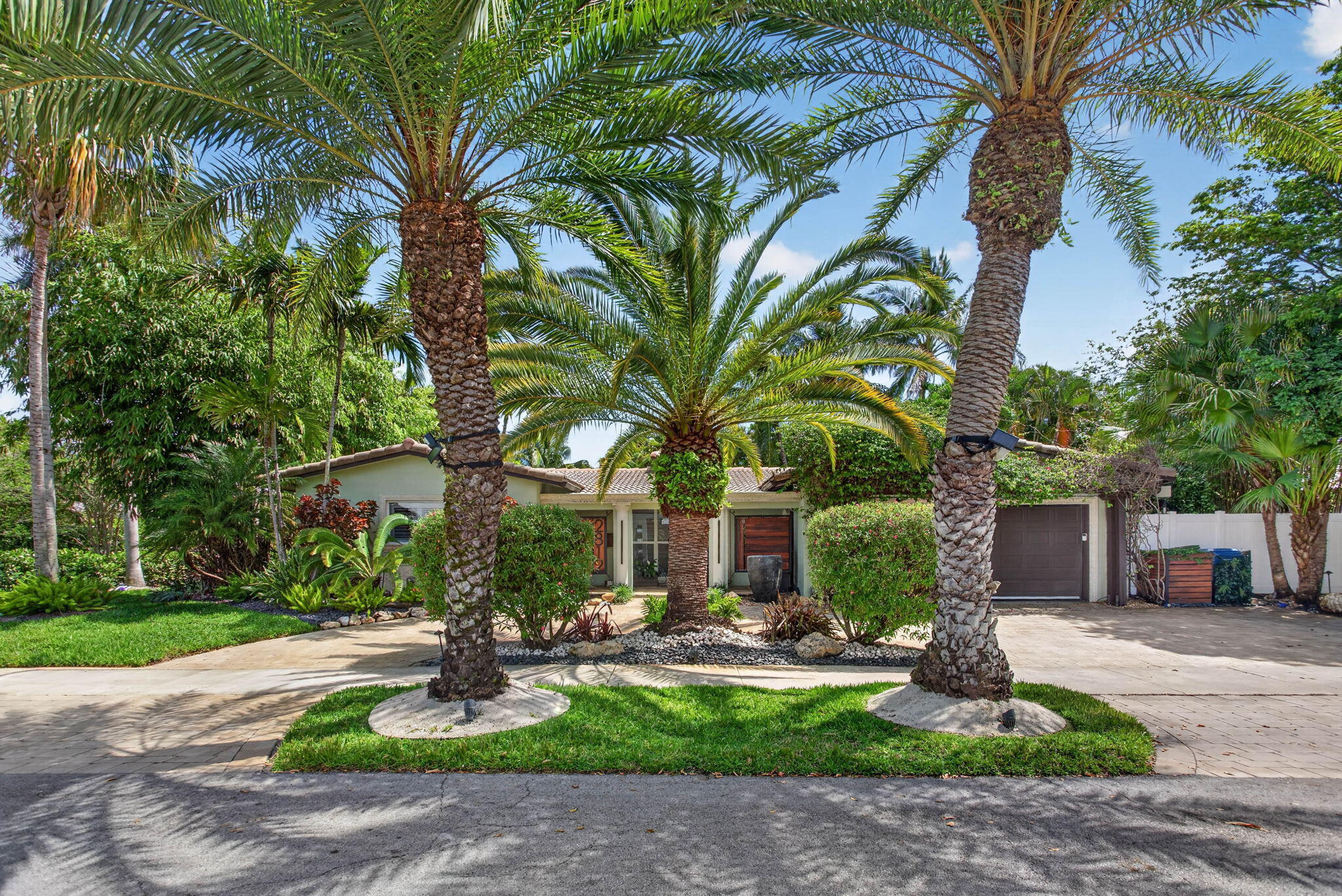Set on a lushly landscaped prominent corner on gated Jenada Isle, this 4 bed 3 bath + den residence was rebuilt with intention and smart home features. Throughout  you'll find custom lighting, electric window treatment, CAT 7/8 wiring, 24-zone Sonos, toto toilets, and Alexa-integrated smart systems run seamlessly throughout. 2 primary suites, both with bespoke bathrooms, walk-in closets, and private outdoor access. Oasis backyard that every friend will be jealous of. A solar-heated saltwater pool, hot tub, heated outdoor shower, and a fully built-out entertaining space with a brand new summer kitchen under a pergola with grill, pizza oven, and refrigerator. Additional features: waterfall, outdoor TV, fire pits, integrated lighting, sound systems, and pool house currently used as an office