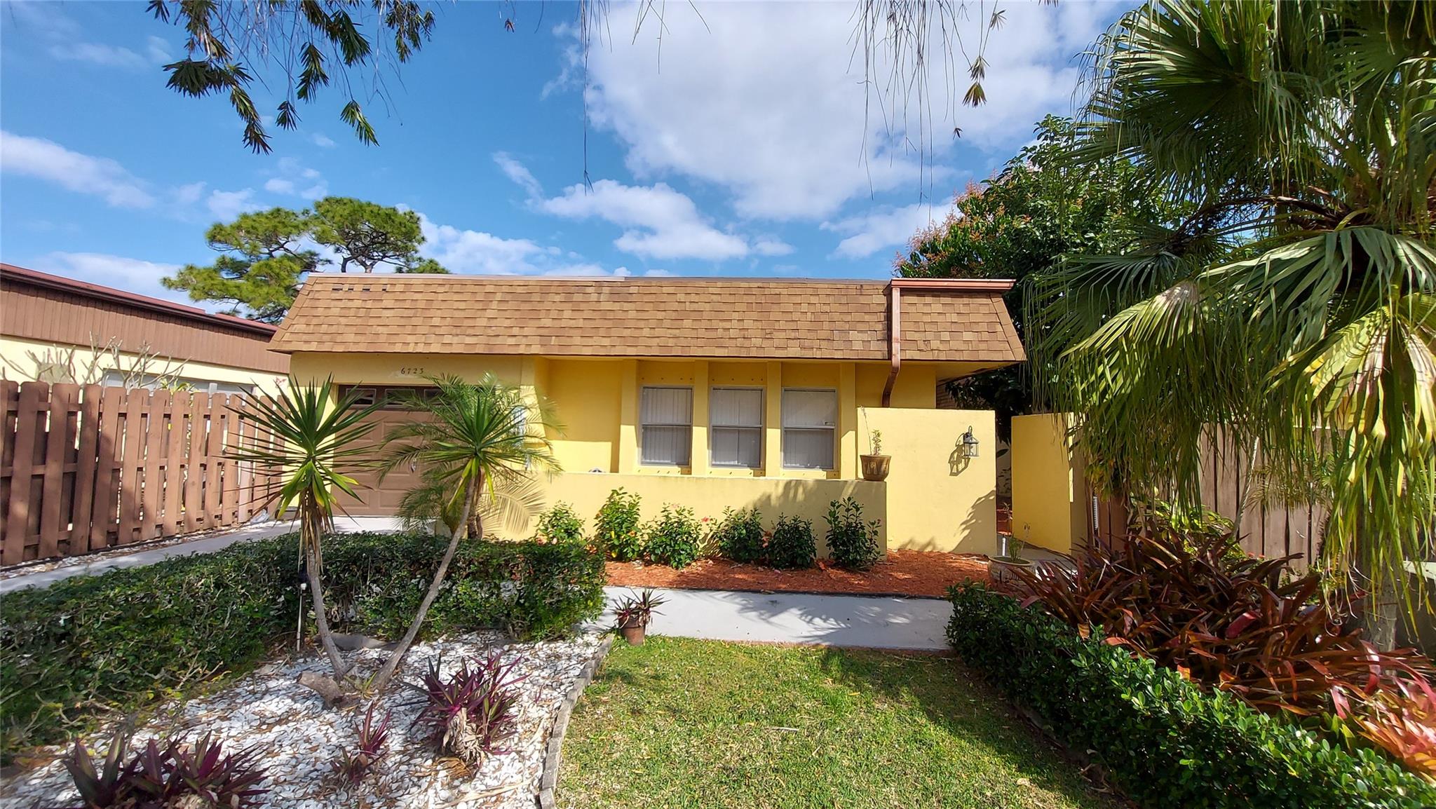 Rare opportunity to own a 3br 2.5Ba 1 car garage in Poinciana Patio Homes. Well maintained 55+ community with low HOA fees. This home boast the best views in the Poinciana Patio Homes, and it is one of just a few stand-alone homes built here. Located between the 5th and 6th holes on the Poinciana Golf Course. This home features a modern updated kitchen and all stainless appliances, tile countertops sure to please any cook. Split floor plan with master bedroom on the back of home with golf course views also. Walk in master closet. Plus It has possibly the longest driveway in the community (able to accommodate 2-3 cars) +one in the garage. Located just steps to the heated community pool. Poinciana also has a community Clubhouse featuring a Main large swimming pool, restaurant/bar fitness center, library, Movies, billiards room, ballroom, shows, sauna, tennis/pickle ball courts, meeting rooms and more. The clubhouse also has a great selection of scheduled activities for everyone. The golf course is a par 64 executive golf course and has three par 5's, four par 4's and eleven par 3's, for a total of 4,560 yards, the course was designed by renowned golf course architect Leon Howard in 1976. Less than 20 minutes to beautiful Lake Worth Beach and fishing pier. Just 7 minutes to the 800 acre+ Okeeheelee Park with hiking and nature trails, bike paths, kayaking and canoe rentals and cable driven wakeboard park. HOA includes Xfinity cable and internet. Close to Florida Turnpike Entrance. If you are ready to jump into the best Florida lifestyle call the listing agent today to view.