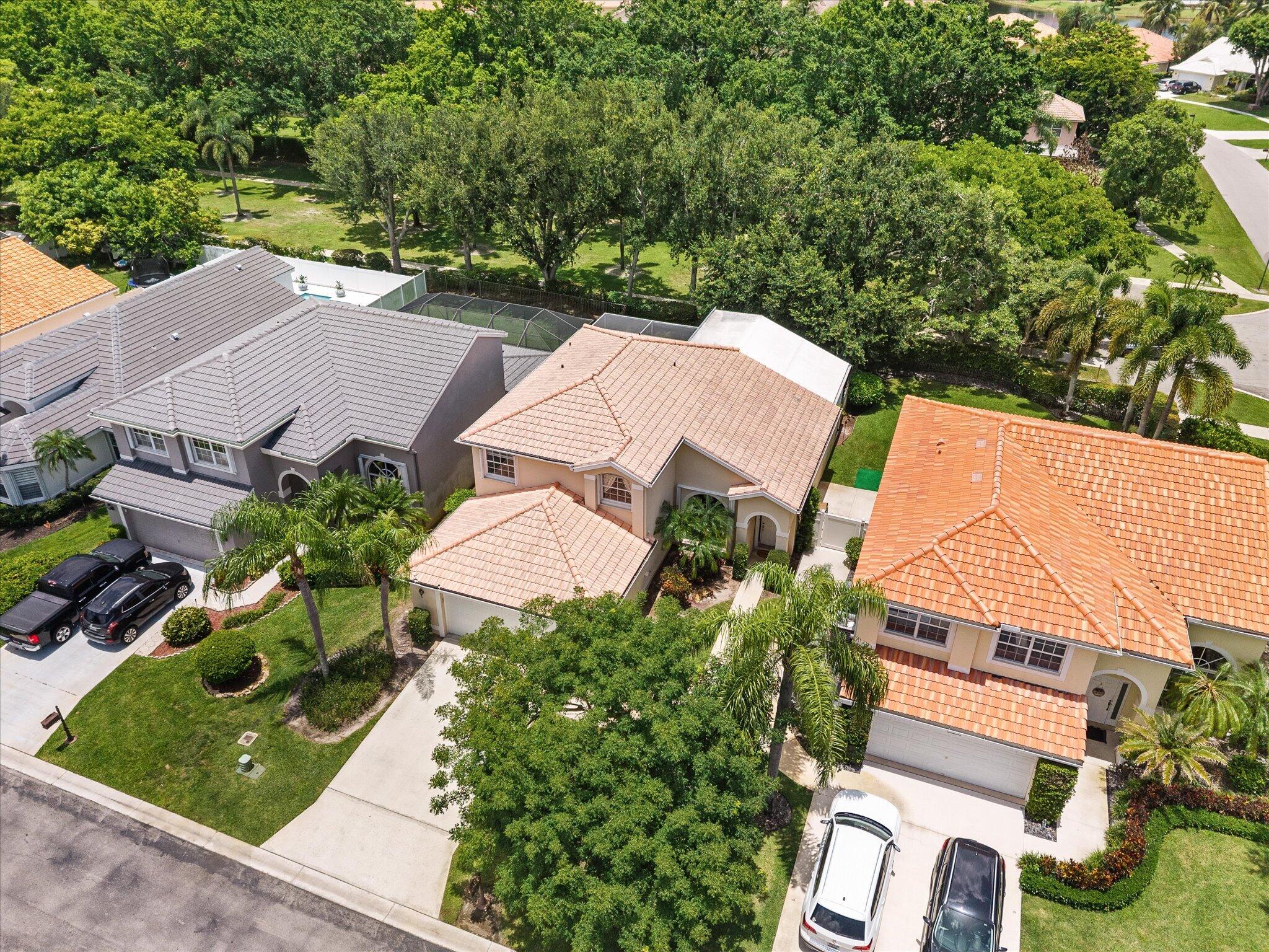 Beautiful, spacious 4-bedroom, 3-bath with a 2-car garage home perfect for a family on a highly desirable lot in The Lakes at Boca Raton!! This well-designed floor plan features master and two bedrooms upstairs as well as a ground floor bedroom and a newly renovated full bathroom, offering flexibility for guests, a home office, or multi-generational living. One of the home's standout features is its spacious backyard, which backs to a park, providing added privacy and a peaceful setting. French doors from the living room open to a covered, screened patio with marble flooring, creating a seamless indoor-outdoor living space. The spacious backyard offers plenty of room for a pool, playset, or custom outdoor retreat.  Inside, you'll find hardwood flooring downstairs and laminate wood upstairs, crown molding, upgraded lighting, California Closets, and abundant storage, including a spacious under-stair storage area. The kitchen has granite counters and stainless-steel appliances and opens to the main living areas, making it ideal for both everyday living and entertaining. Additional highlights include a laundry room with extra cabinetry, a utility sink, and an alarm system. The sought-after Lakes at Boca Raton community offers residents a clubhouse with a resort-style pool, fitness center, BBQ area, playground, tennis/pickleball courts, basketball courts and a mini soccer field, all within walking distance from the house. This home is located in a highly regarded school district, with students attending Sunrise Park Elementary and Eagles Landing Middle School.