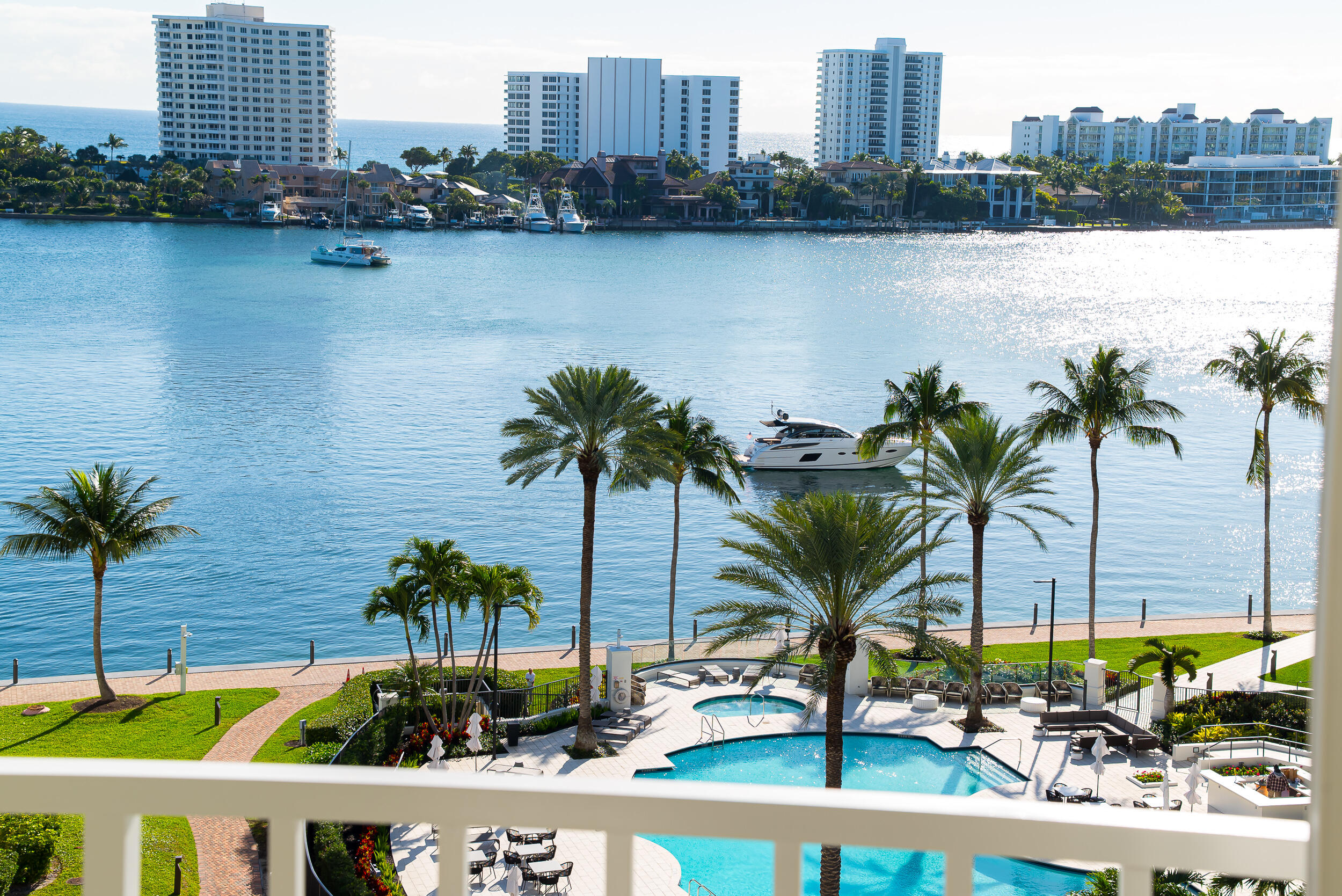 Enjoy the East (Ocean), West (Sunset) views of this Mizner TOWER PENTHOUSE with soaring 22-foot ceilings, an exceptional blend of luxury, privacy, and the coveted waterfront lifestyle on the grounds of The Boca Raton. This 3-bedroom, 4.5-bath residence offers 2,544 livable square feet designed to maximize comfort, light, and seamless entertaining.  APPROVED - Transformation of Front Portico & Pool Deck - Sleek & Modern Design   A corner residence flooded with natural light, it features NEW full impact hurricane windows and doors, newer 2 Zone HVAC, a gourmet kitchen, and an expansive wraparound balcony where you can start your mornings with sunrise ocean breezes and unwind with sweeping Lake Boca, Ocean, Intracoastal, golf course, and city views.  Impeccably maintained after a high-quality designer renovation, the home offers timeless modern elegance. Designer furnishings negotiable for a truly turnkey experience.  The split-bedroom layout provides privacy for you and your guests, with a serene primary suite offering double walk-in closets and luxurious His and Her baths, your personal retreat after a day at the beach, golf, boating, or enjoying the resort amenities just outside your door.  Located within the private, gated grounds of The Boca Raton Resort & Club, you'll enjoy unmatched walkability to world-class dining, the beach, shopping, and downtown attractions, making everyday living feel like a 5-star vacation. (Resort membership not included.)  Mizner Tower is a pet-friendly, full-service building offering valet, concierge, security, pool w/towel service, fitness center, tennis, lounge with lite snacks and marina access, everything you need to live the effortless, resort-style East Boca lifestyle you've been searching for.  All assessments paid in full by Seller.