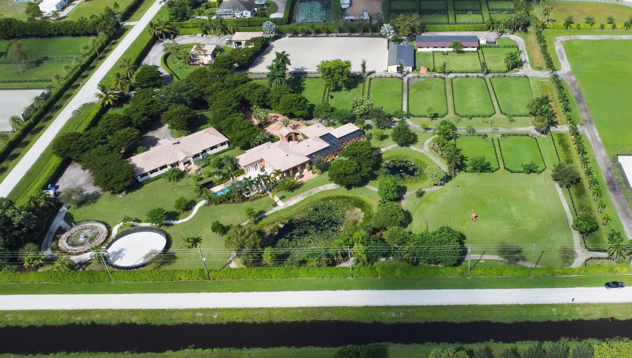 Stunning 9.54 acre farm  with an additional  4.77 acre lot next to it also for sale. A one of a kind ''ZEN'' like atmosphere with  1 main 3/3 house and two lovely guest houses for an additional 3 bedrooms, 34 stalls, ring with mirrors, horse walker, workout track,tons of paddocks, huge extra garage for equipment and parking.  This farm is close to polo and all equestrian activities . Just 25 mins to Palm Beach, the ocean and 20 mins to a major airport .  This farm will not disappoint see Rx-11030537 and rx 10931903