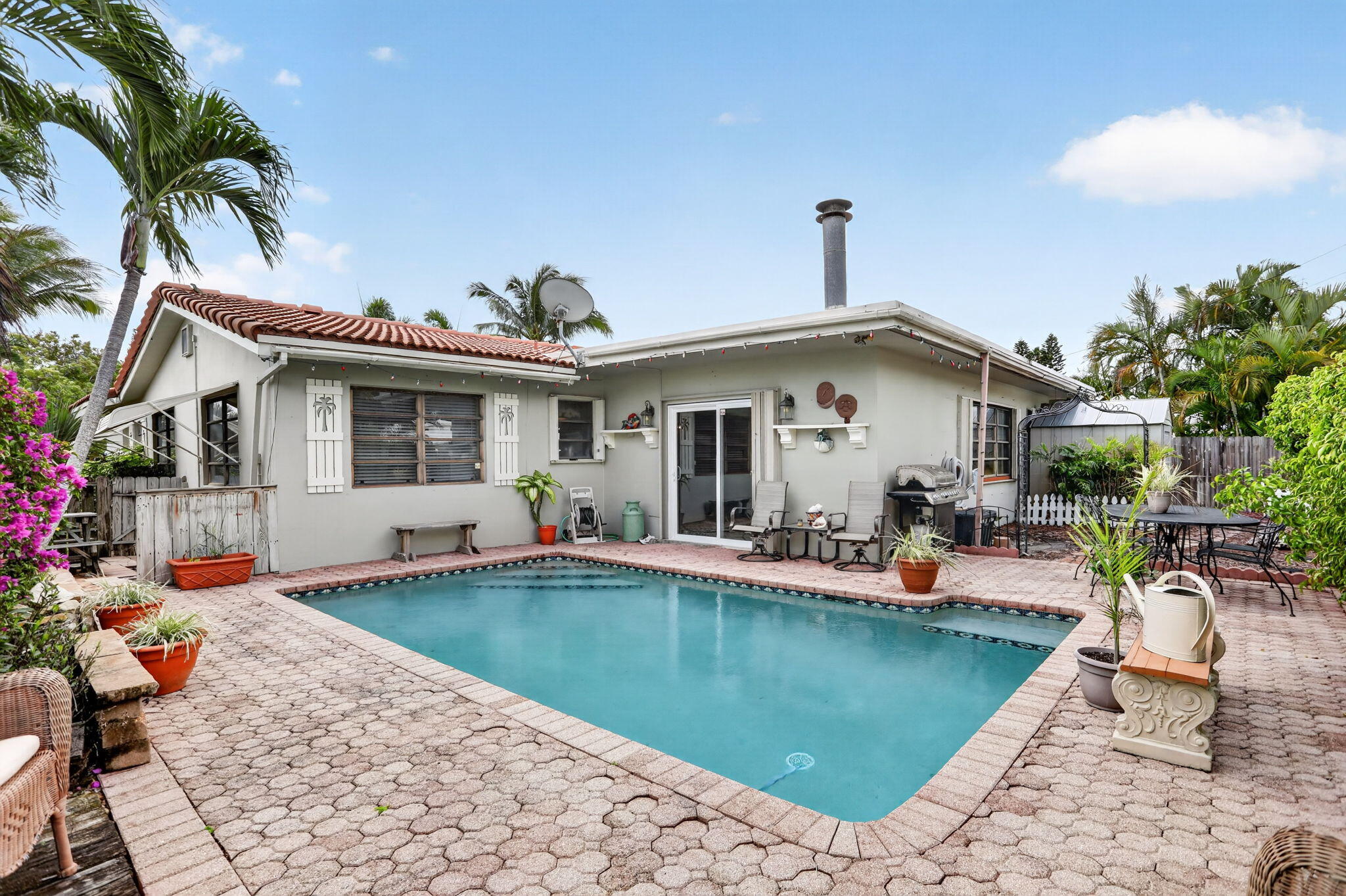 Nestled in Lighthouse Point, one of South Florida's most prestigious and highly sought-after waterfront communities. This 3-bedroom, 2-bathroom residence presents a rare opportunity to create your dream home in an exceptional location known for its walkability, charm, and coastal lifestyle. Set on a beautifully landscaped lot, the property features an inviting below-ground pool and spacious outdoor area—perfect for entertaining or designing your own private tropical retreat. Inside, 1,944 square feet of living space offers a functional layout ready for your personal vision. Surrounded by multi-million dollar homes and just minutes from marinas, dining, shopping, and South Florida's pristine beaches, this property combines lifestyle, location, and limitless potential.