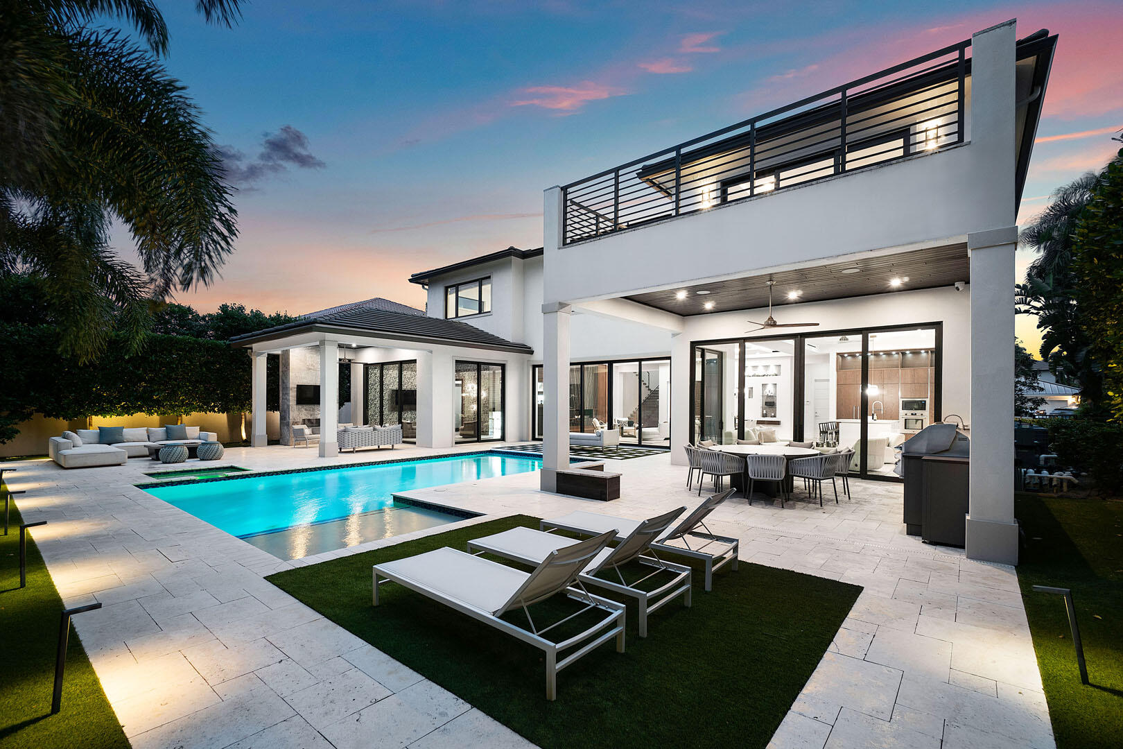 Introducing 2324 Date Palm Road, an architectural triumph by Primo Construction and Cosentino Architecture, located in the prestigious Royal Palm Yacht & Country Club. This extraordinary 2020 estate showcases Italian luxury craftsmanship, blending modern design with unparalleled attention to detail.
The home embraces the outdoors with two covered terraces and seamless indoor/outdoor living. Floor-to-ceiling sliding glass doors flood the interiors with natural light and offer breathtaking views of the resort-style saltwater pool. This private oasis features a sun shelf, water sprays, and a spa, creating the ultimate retreat. The terraces are designed for entertaining, with a summer kitchen, built-in 48'' BBQ, stone fireplace, and mounted television. The home boasts six spacious bedrooms, a bonus room, seven full bathrooms, a family room, a media room with a sleek bar and, and Control4 smart-home automation, providing effortless control of cameras, lighting, music, climate, and pool settings. Premium finishes include imported porcelain floors, Pompei quartz counters, translucent pressure-treated stone walls, and custom Italian cabinetry and appliances. The open-concept design is both stylish and functional, offering an unparalleled sense of space and​​‌​​​​‌​‌​​​‌‌​​​‌‌‌​​‌​​‌‌​​​​ comfort.