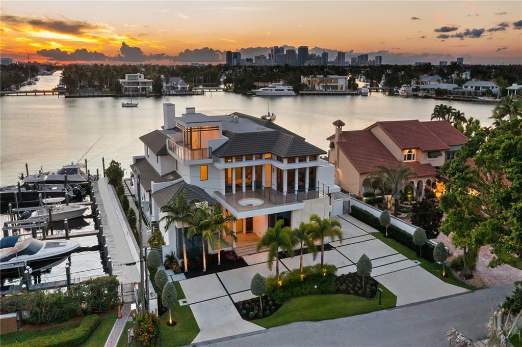 1425 E Lake Drive is a modern coastal masterpiece in prestigious Harbor Beach, Fort Lauderdale. Designed by Randy Stofft Architects and built by Sarkela Corp in 2019, featuring 8,723 SF of extraordinary design, functionality, and superior construction. A complete oasis outback offering 100ft deep waterfront dockage, a custom pool, chef’s cooking space, and expansive water views. Main level: Gourmet kitchen w/ Wolf and Sub-Zero appliances; wine wall; 2-sided fireplace; glass-enclosed office opens to club room; elevator and main level suite. Upstairs: four bedrooms upstairs - each with luxury baths and balconies. Laundry room on both levels, a private rooftop terrace, and intelligent tech(Sonos, Lutron + Energy Star).Harbor Beach offers security with private beach and quick ocean access.