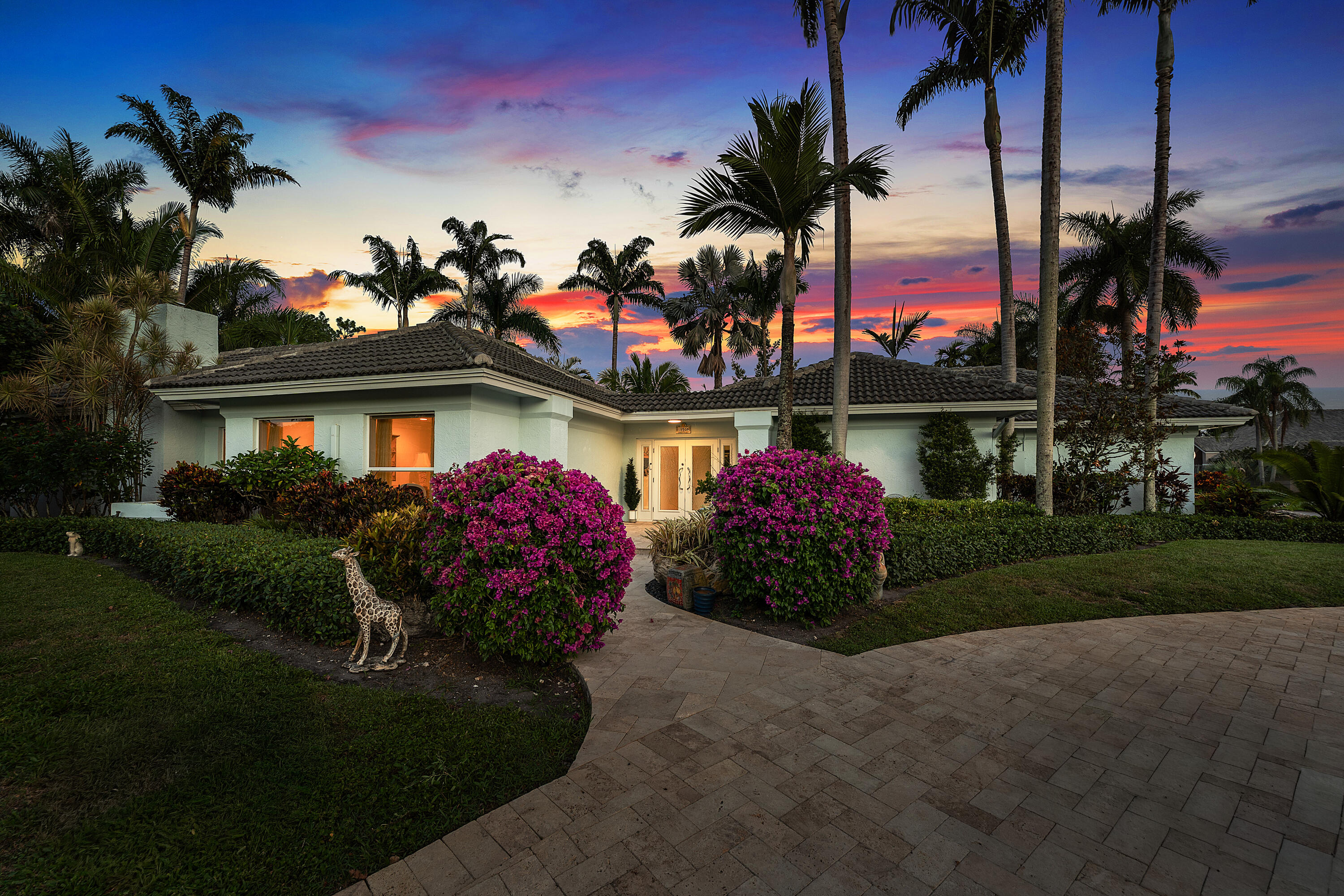 Experience refined Florida living in this exceptional 5 BR, 3 BA courtyard residence on an oversized corner lot within prestigious Delray Dunes Golf & Country Club. Built around a private pool courtyard, the home blends indoor and outdoor living, while a spacious side yard framed by mature landscaping offers rare privacy and room to entertain. Inside, elegant living spaces feature beautiful Saturnia flooring and a working fireplace that adds warmth and timeless charm. The gorgeous primary en suite is a true retreat. A newer roof, full impact protection, 2-car garage and dedicated golf cart garage complete the home. Enjoy championship golf, tennis, fitness, fine dining and a vibrant social calendar, minutes from downtown Delray Beach and pristine beaches.