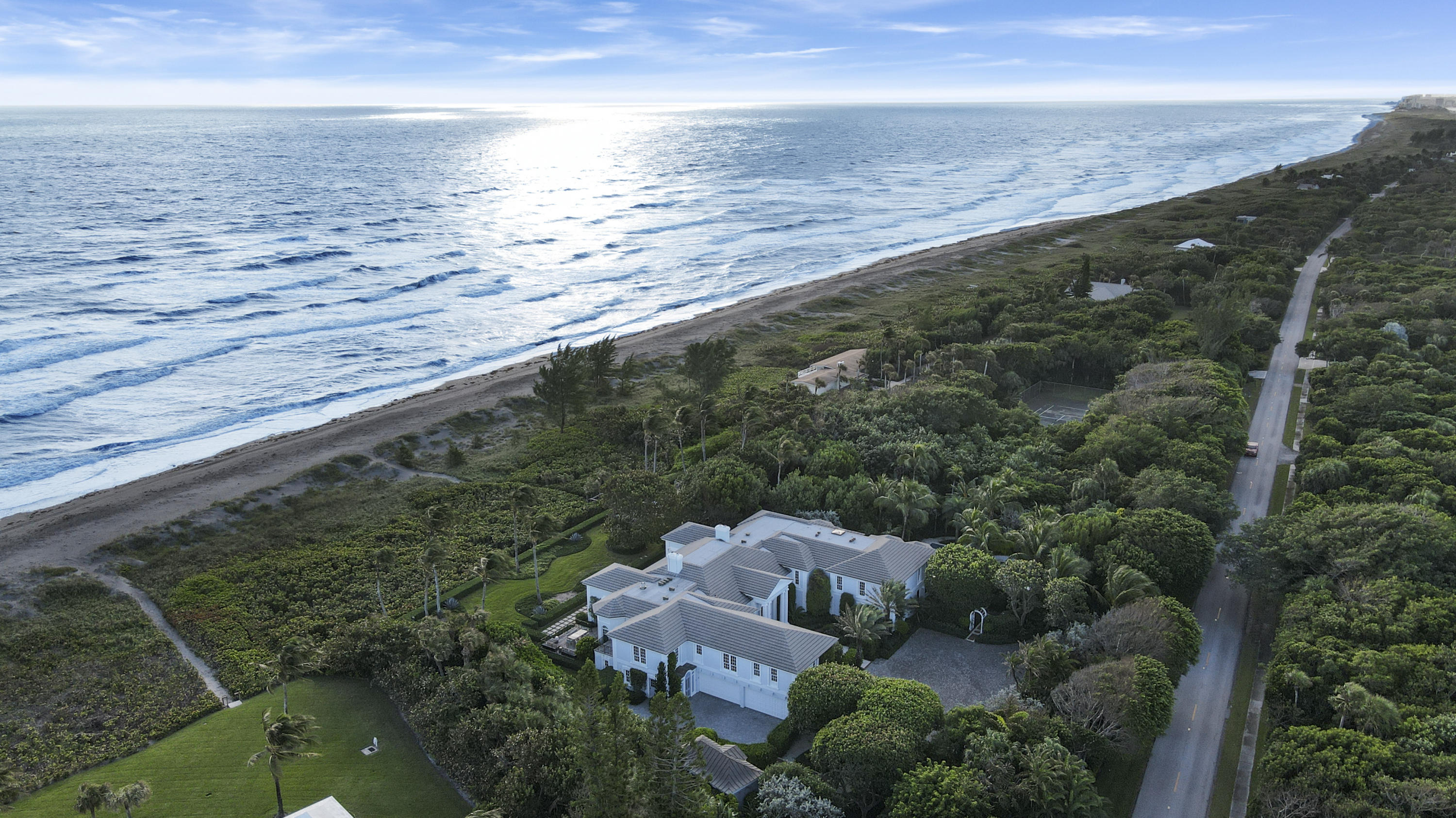 Located on prestigious Jupiter Island, this breathtaking property spans nearly 2.5 acres with an astounding 255 feet of direct ocean frontage. Recent renovations bring a delightfully new, bright and open feel to this spacious 2 story residence. Over 10,000 sq. ft. includes an open chef inspired gourmet kitchen, custom wine cellar, private elevator, six bedroom split floorplan providing maximum privacy for your master retreat, while providing guests with 5 star accommodations. Numerous rooms including a state of the art theater, will entertain and accommodate many family members and guests. Lush landscaping creates a complete private and secluded outdoor entertainment paradise. This property is sure to impress even the most discriminating of buyers