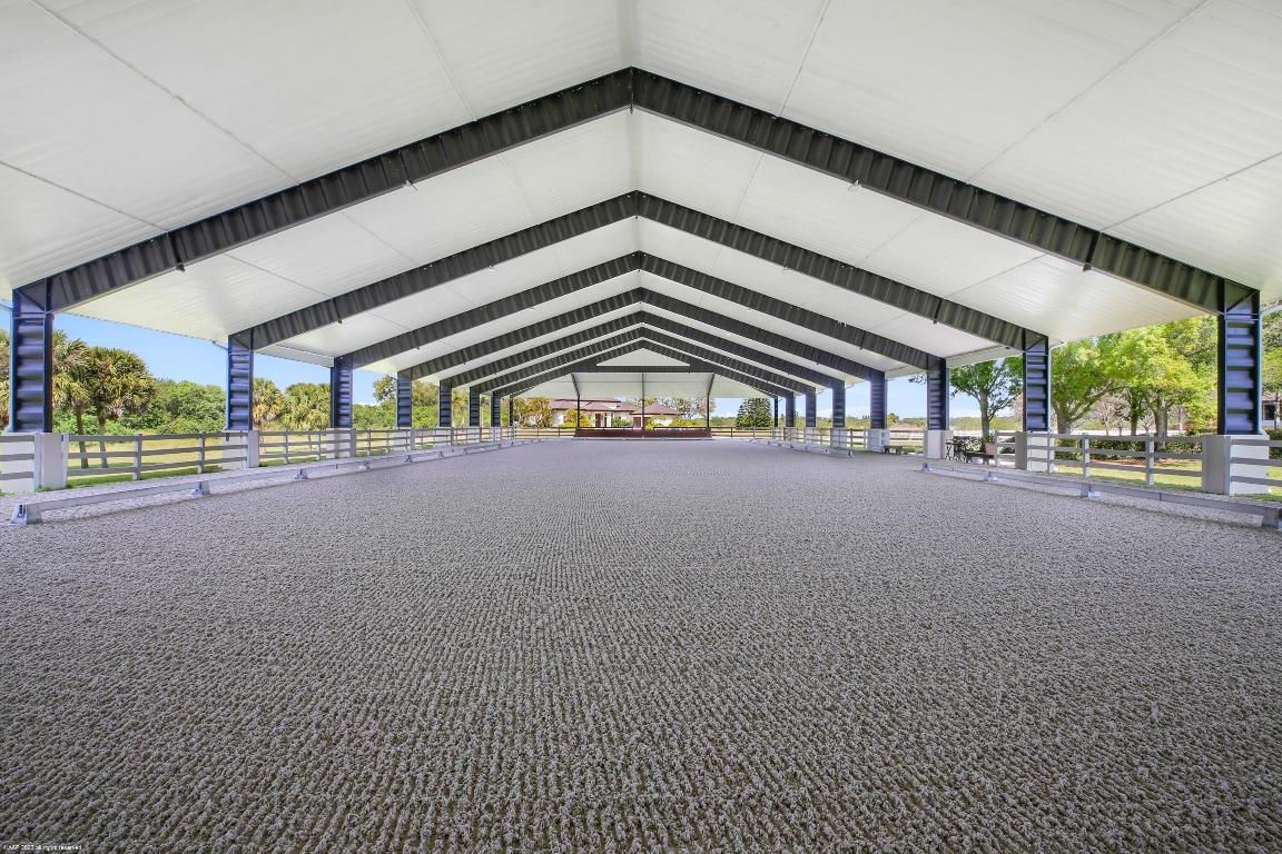 Updated in 2023, this 14.63-acre farm with 20-stall center-aisle barn has 2 tack rooms, a covered patio overlooking the 100' X 213' covered riding arena with GGT footing, mirrors & observation platform. There is also an outdoor riding arena with mirrors and new gazebo. Other features include: a round pen, a 51' X 86' storage garage, detached staff house with two apartments with 4-bedrooms total. The owner's residence has 4-bedrooms plus an office, private pool & fenced backyard with water views. The home was completely updated from top to bottom in 2023. The kitchen boasts double islands with waterfall edge quartz counters and oversized walk-in pantry. This equestrian estate offers everything a serious equestrian could desire! More contiguous acreage available, see supplement for details. There are two contiguous vacant parcels currently listed for sale by a different owner. Combine for a total of 29.95 Acres or 44.27 Acres. 

Lot 16 immediately adjacent to the south is 15.02 acres listed for $795,000 (MLS#:RX-10493596).

Lot 15 is 14.62 acres & listed for $750,000 (MLS#RX-10493560).
Ask listing agent for more details.