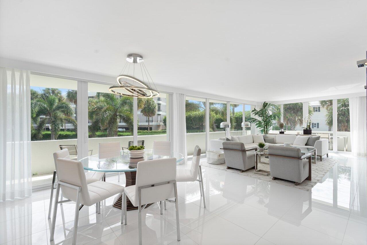 Chic Contemporary In Town..Rare private corner 3 bedroom, 3 bath beautifully executed open floor plan appointed with the highest caliber of materials and finishes throughout. Flooded with natural light that offers east facing ocean views and sun kissed southern exposure. Highlights include a sleek Balthaup European kitchen, Wolf and Subzero appliances, Glassos flooring, custom lighting, fitted storage, impact glass sliders and a deep wrap around terrace. Sought after full service building offering 24/7 security, doorman, valeted 2 car garage, large fitness center, pool service and direct beach access. Nearby fine dining, upscale shopping, cultural activities & The Breakers Resort. Pets Permitted.
