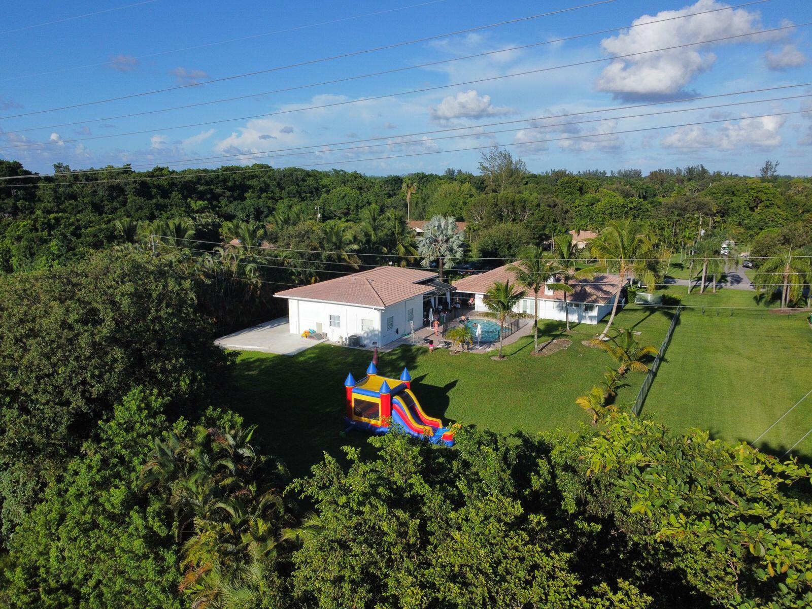 Spectacular opportunity to own this single-story home, located in the secluded community of Davie. Sitting on nearly a builder's acre- this home offers 3 Beds / 2.5 Baths plus a Detached Guest-House. The main house shows high vaulted ceilings, all renovated bathrooms, a 2-car garage, and a custom eat-in kitchen complete with a center island, gas stove & separate breakfast nook. The home features a New A/C, New Water Filtration System, hurricane shutters, and a New Washer & Dryer. The Second Home boasts approximately 1,600 sqft with 1 Bed / 1 Bath, high volume ceilings, central A/C, 3-car garage, all New Tile Flooring, and shows a New concrete slab alongside it. Best of all the home offers a resort-style pool area overlooking the oversized backyard and open green areas.  new roof will be install with full price