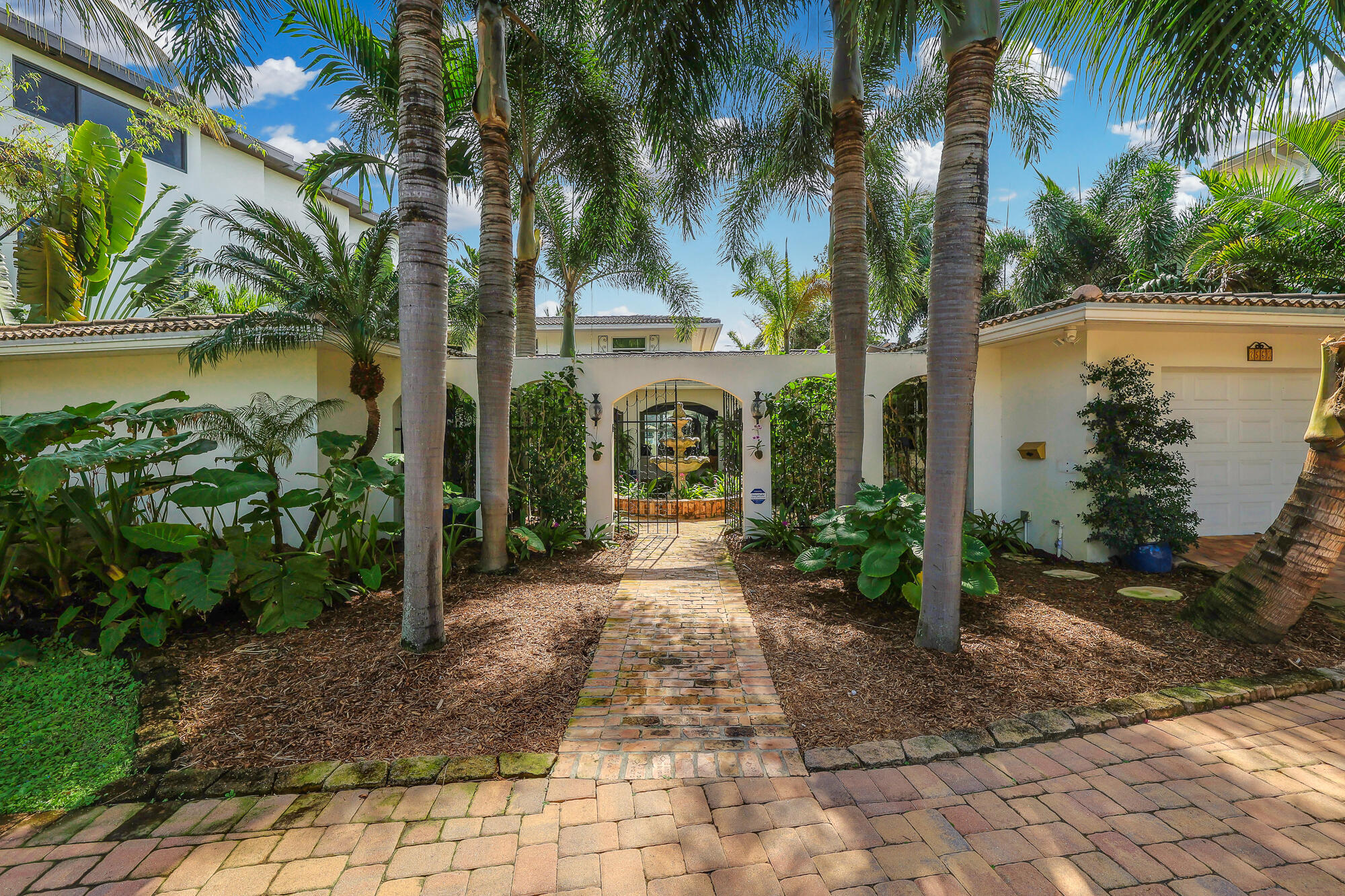 ENDLESS VIEWS! This luxurious Waterfront Estate has infinite views of Lake Santa Barbara and the intracoastal waterway. Walk through the wall to wall impact sliding doors to enjoy a relaxing swim in the salt water lagoon style pool (which is heated) or sit back and enjoy the beautiful sunsets. Impact windows throughout. 3 A/C's replaced 2020 under warranty. There are so many extras to see here. LED lighting surrounds the pool. A Tiki hut where you can enjoy a drink with friends. The lush tropical landscaping gives you the feel of being in paradise. Chef's kitchen with natural gas cooktop. Finger dock and dolphin pilings that can host a large boat/yacht with no fixed bridges. Seawall in good condition. Easy access to the Ocean. This home is a must see.