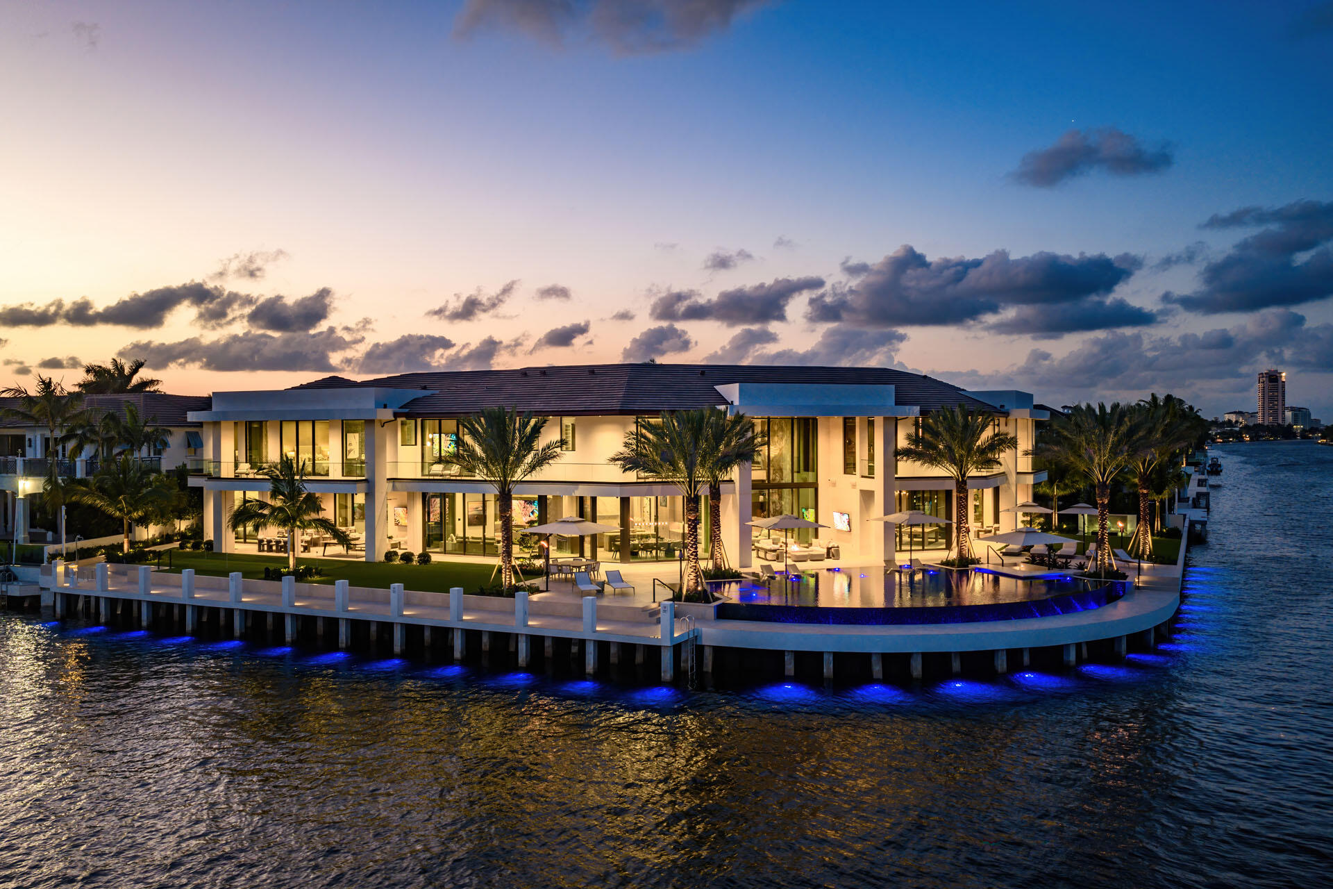 Introducing the most significant waterfront estate ever completed in Boca Raton, positioned on a rare trophy point lot within Royal Palm Yacht & Country Club. 2500 E Maya Palm Drive offers 292 feet of waterfront, spanning nearly an acre and delivering a level of scale and presence that is rarely achieved and virtually impossible to replicate.     Conceived and executed by the esteemed SRD Building Corp., with interiors masterfully curated by the award-winning P&H Interiors, the residence is a study in precision and proportion. Every element has been deliberately designed to evoke a sense of ease while delivering uncompromised performance, with advanced home technologies quietly orchestrating comfort, security, and control at the highest level. Spanning over 24,000 total square feet, with more than 18,000 square feet under air, the estate presents eight bedrooms, ten full baths, and five half baths—each space layered with intention and refined materiality. Dual primary suites offer private sanctuaries of scale, while two dedicated offices provide an executive environment for work without compromise. The home's amenities rival those of a private members' club. A fully realized wellness wing introduces a new standard of in-residence rejuvenation, complemented by a state-of-the-art fitness center. A club room anchored by a dramatic video wall, along with a high-tech golf simulator and game room, delivers immersive entertainment experiences designed for both intimate gatherings and grand-scale hosting.   Arrival is both discreet and commanding, with a gated motor court leading to six-and-a-half garages that accommodate collections with ease. Beyond, a 110-foot private dock offers direct access to the Intracoastal, while the home's prized southeast water exposure captures both morning light and sweeping, cinematic vistas throughout the day. Positioned moments from pristine Atlantic beaches and neighboring The Boca Raton Resort & Club, the estate is also within immediate reach of the area's most distinguished shopping, dining, and leisure pursuits, placing the best of Boca Raton at your doorstep while maintaining a sense of complete privacy. This is not simply a residence, but a definitive statement of how scale, setting, and execution converge to create the most significant offering ever to come to market in Royal Palm Yacht & Country Club.
