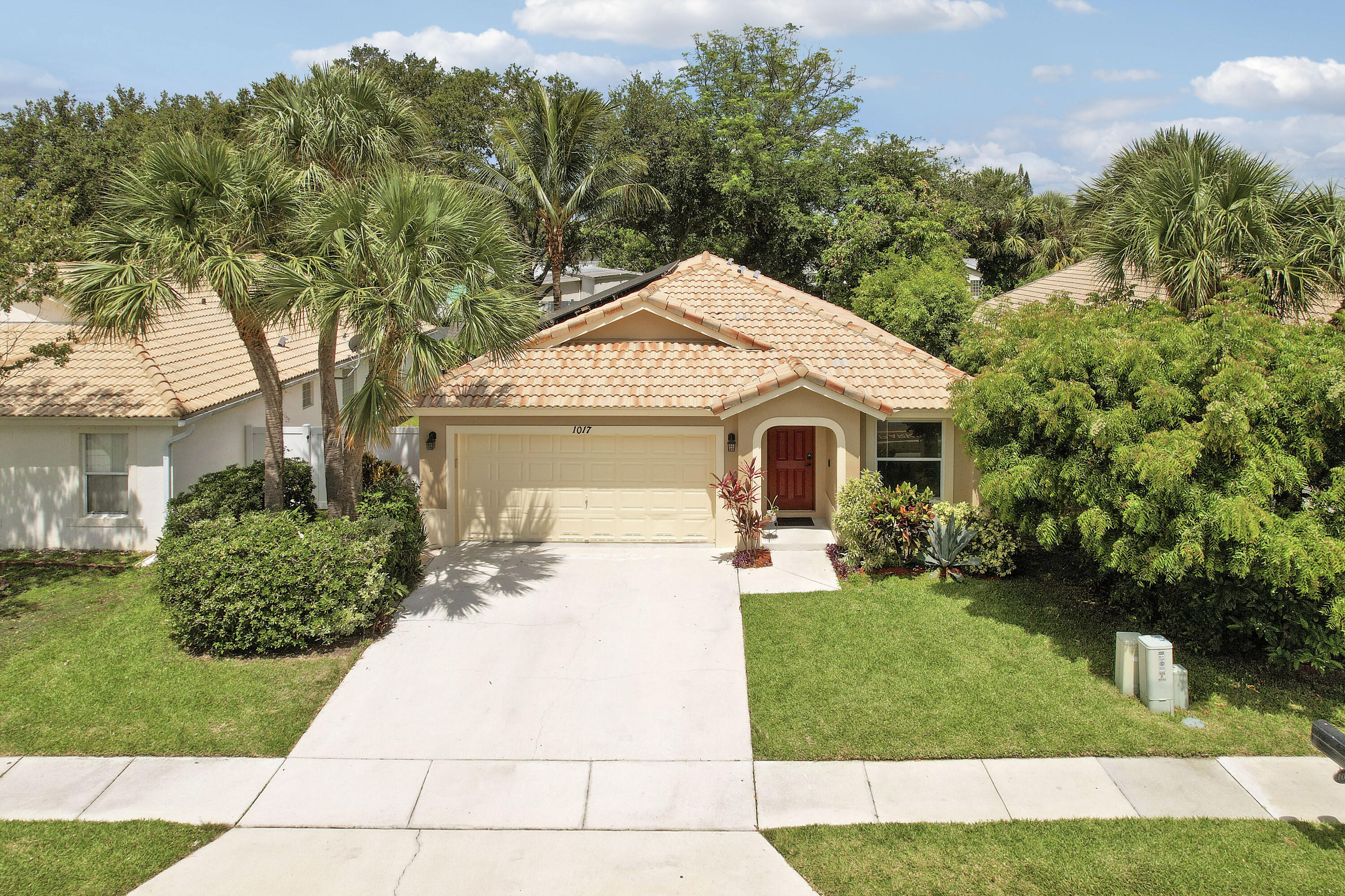 Welcome home! This move-in ready 3-bedroom, 2-bathroom single-family home in Boynton Beach offers approximately 1,658 sq ft of single-story living with a low HOA fee. Built in 2000, the open-concept floor plan features vaulted ceilings, tile flooring throughout, and abundant natural light. The kitchen showcases wood cabinetry, granite countertops, and stainless steel appliances, flowing into the dining area and spacious great room. The primary suite includes a walk-in closet and renovated en-suite bath with a dual-sink vanity and glass walk-in shower. Outside, enjoy a private, fully fenced backyard with an expansive travertine paver patio. Located in Palm Beach County near shopping, dining, and major roadways. Schedule your showing today!