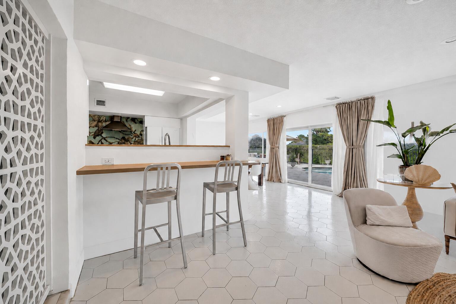 Palm Springs meets South Florida in this distinctive mid-century residence in The Woodlands. Clean architectural lines, expansive walls of glass, and generous living spaces create a relaxed resort-style atmosphere with seamless indoor-outdoor living. Authentic hex tile flooring adds architectural character, while the updated kitchen, renovated primary bath, impact windows and doors, and lush tropical landscaping provide modern comfort. Enjoy a private pool, tranquil green-space views, and the opportunity to personalize over time. Conveniently located just moments from the Florida Turnpike, commuting throughout South Florida is quick and easy. A rare opportunity to enjoy the established beauty and mature landscape of The Woodlands while becoming part of its exciting next chapter.