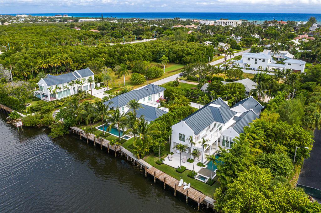 Easy breezy and beautiful..sophisticated and luxurious, this hip contemporary residence offers a dramatic view from every angle.  Just beyond the glass foyer entryway, guests are greeted by a gorgeous grand room surrounded by floor to ceiling doors affording extensive views of the Intracoastal and tropical gardens.   With 80' of direct water frontage, the home offers a superb open floor plan, which features 6182 TSF square feet, 4 bedrooms, 4.1 baths, epicurean kitchen, custom European cabinets with high gloss exotic veneers, Caesar stone and top of the line appliances from internationally acclaimed brands. Chic recessed baseboards and reglet ceiling details add to the allure of every room.  The ground floor luxurious master suite is the perfect backdrop for serenit sitting room/office a state of the art bathroom, his and her vanities, garden tub and large shower. Equally appealing is the second floor with three large guest suites plus an entertaining loft. /Allowing a delightful play of interior and exterior surroundings are the large glass doors, which open to a tropical resort styled pool complete with sunning bar. Enjoy endless sunsets from the covered loggia adorned with cypress ceilings, outdoor kitchen, gas fireplace, new seawall and dock combining to create an outdoor oasis for entertaining which todays discerning buyer seeks. Enriching diversions...only moments away.