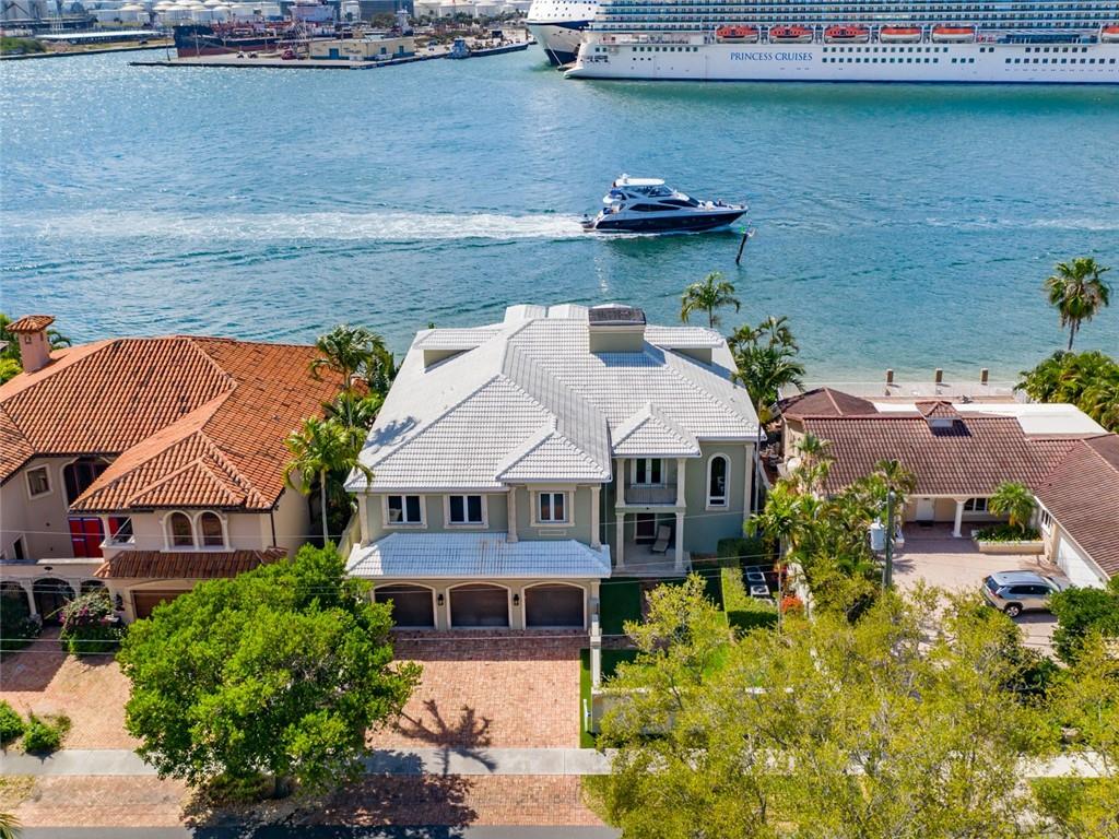 Sought after and rarely available Harbour Inlet waterfront estate, featuring incredible views of mega yachts and cruise ships 7 days a week! Breathtaking sunsets & gorgeous downtown views. A spacious 2nd floor balcony spans the length of the home. 4 large bedrooms with office/gym, a full house automatic generator, water purifying system, wood floors, impact windows, large kitchen with island and huge pantry. Beautiful coffered ceilings with crown molding, wet bar and commercial elevator with access to 3rd floor air conditioned attic. Large master suite with 2 huge master closets.  The oversized concrete dock & 11X50 ft. lap pool is fun for all social gatherings. Artificial turf and a complete mosquito misting system. Generous 3 car garage. Interior photos week of April 5th. Interior photos scheduled for week of April 4th. Showings begin April 7th.