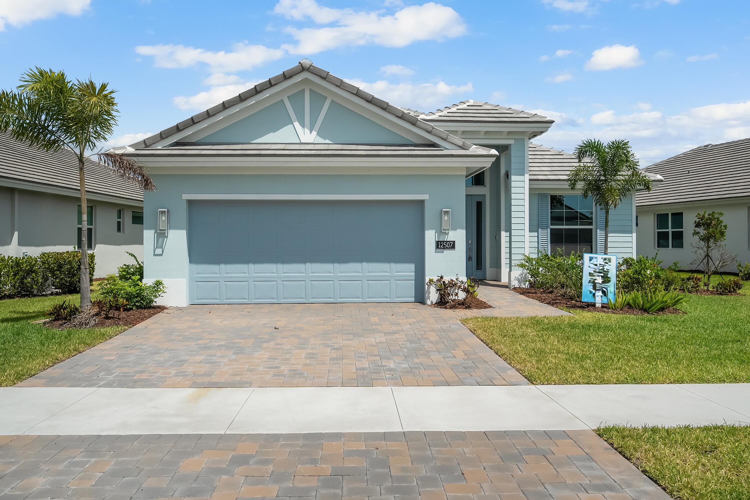 This welcoming 2 bedroom, 2 bath plus den home provides soothing colors indoors and out. The Island elevation with 4' garage extension is accented with blue and white tones. The interior is inviting with white and grey tones in the kitchen with upgraded tile backsplash, glass cooktop and double wall oven, plus 3 boxes above the kitchen island for future pendant lights. The laundry room is finished with upper and lower cabinets including a drop-in laundry tub. The office is accented with double single-lite glass French doors. Pocket door at master bath water closet. Tile flooring throughout the home plus a floor outlet and 4 hi hats in great room. The lanai is finished with an exterior wall mount TV package.