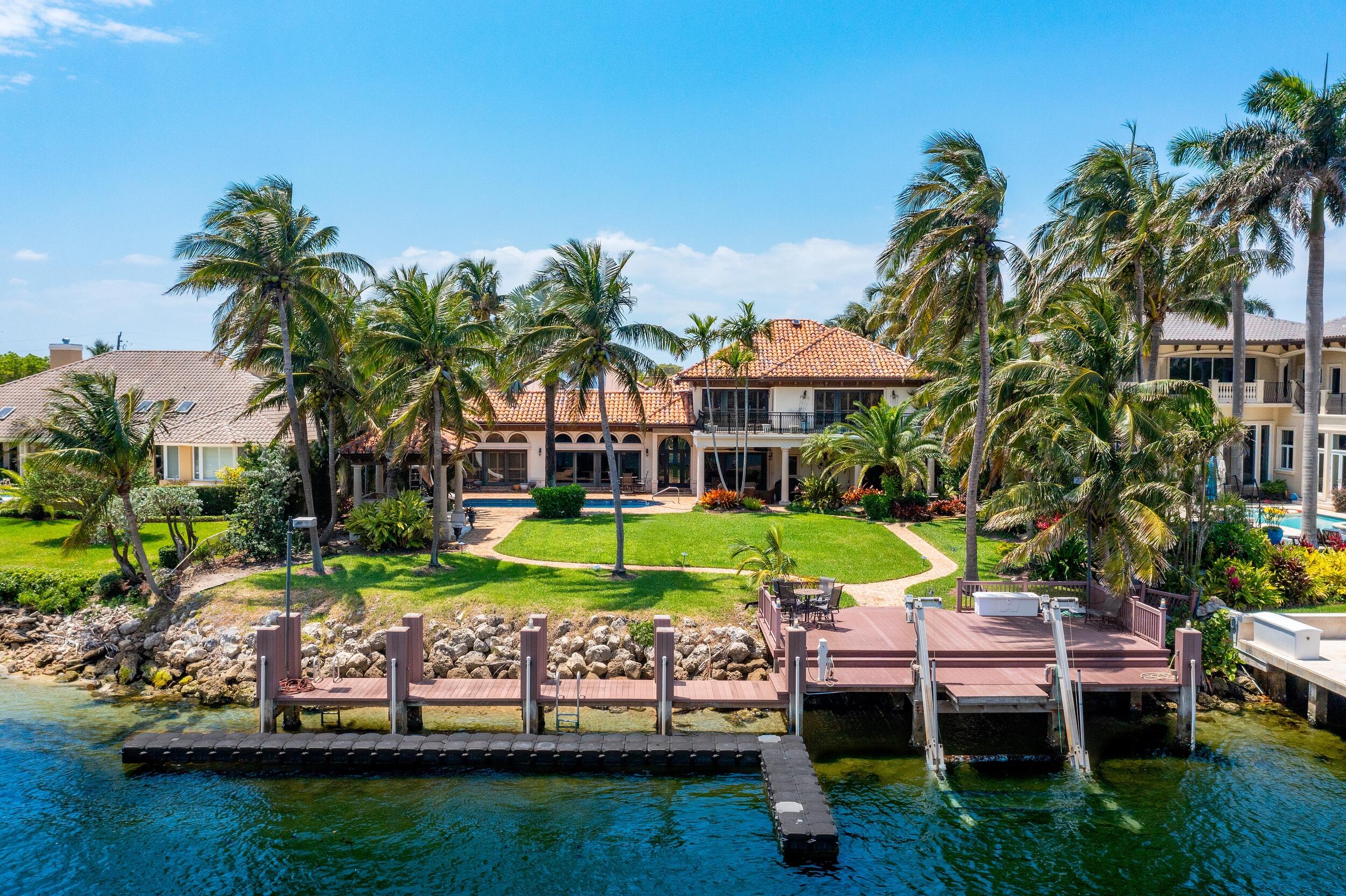 This very classy and comfortably spacious Mediterranean house is a must-see home for anyone looking for a large home with the ultimate lot, directly on the Intracoastal. The house features 5 bedrooms, including an upstairs huge master suite with genuine mocha colored hardwood floors, and a large sitting area with a magnificent view of the Intracoastal waterway from both the bedroom windows, or better yet, the large wrap around outdoor balcony. In addition, you will find another master suite on the first floor, and three more bedrooms, including one that is currently set up as an office. The living room and family room, which is separated with a classy bar area that is ideal for entertainment, both have beautiful marble floors and very high ceilings, which extends into what is also a very large and classy kitchen. The overall space with the open floor plan and vaulted ceilings really makes the house seem even bigger than its 6,024 square feet of living space. And when you are in the back yard, you will be sure to again take notice of how spacious it is too, with an outdoor living area, a dining area, all covered with a beautiful porch ceiling in Pecky Cypress Wood, come rain or shine.
Classic Chicago Brick pavers cover a large part of the back yard and pool area but leaves more than enough room for a large and beautiful lawn with its own paved pathway down to the dock area, or over to a Gazebo with and outdoor kitchen and bar. By the dock there is also an outside seating area, and the dock itself can accommodate a very a large vessel.
In conclusion, this house in Lighthouse Point, one of the most beautiful and family friendly areas in Broward County, must be seen to be appreciated!