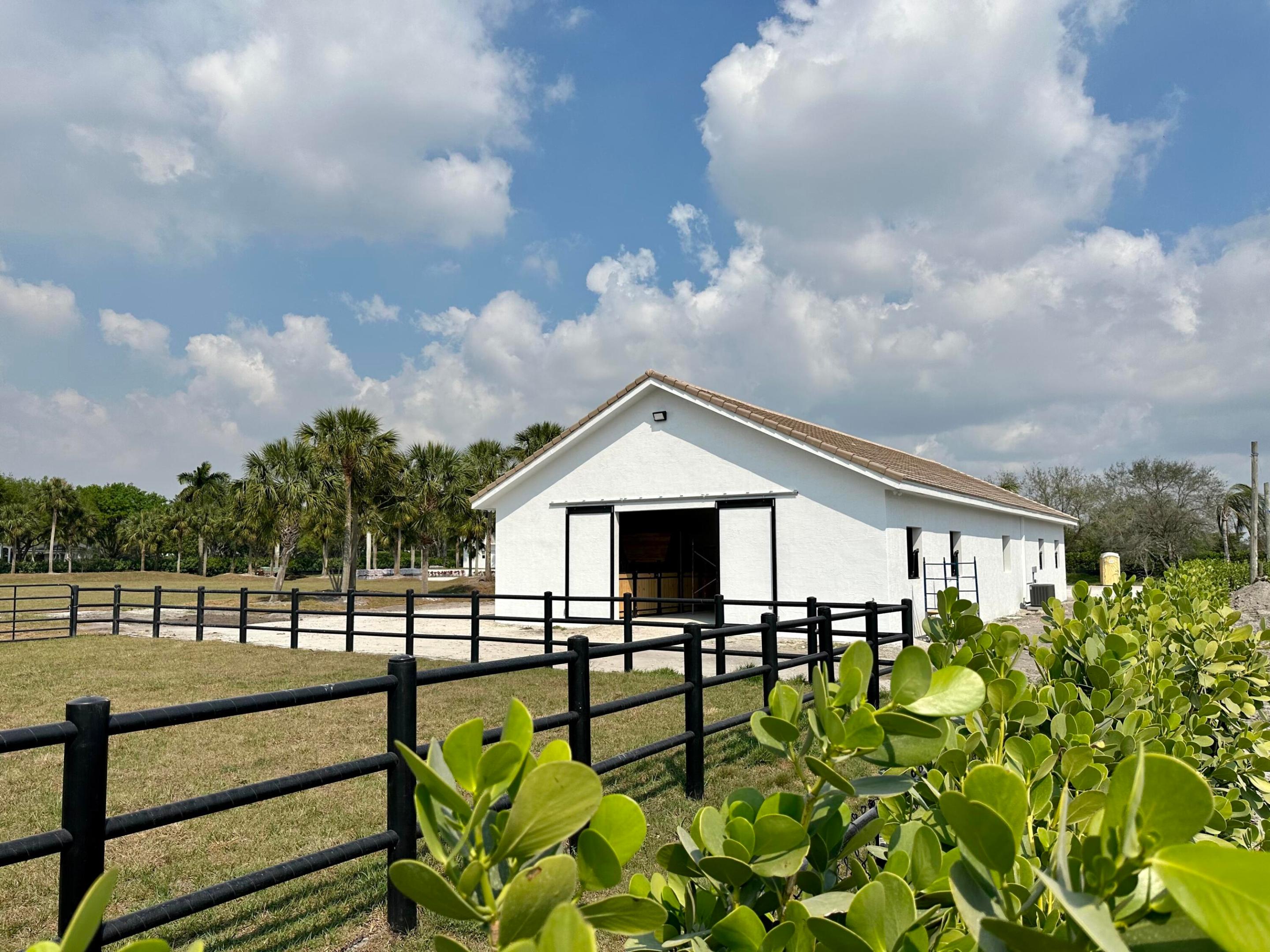 Southfields Paradise!  Also available to lease beginning 10/1/24 for the 6 month 24/25 season  16 stalls, 8 in new barn/8 in tent, 2 renovated &  furnished apartments (one 4/3/1 and one 2/2/1), impact windows.  GCT arena, 6 horse walker, grass jumping field with natural obstacles,  5 generous paddocks, 2 electrically gated driveways with turnaround AND a giant 150 ft by 200 ft space to expand. Add another residence, another barn, a covered arena (ok on 5 acres in Southfields), more paddocks - or just enjoy the grassy open space.  Southfields is the ''place to be'' with lots of turnover and new development.  It is ideally located between horse show venues and a straight shot to the new Wellington International entrance.  ACT NOW to make Southfields your equestrian home.  MUST-SEE property