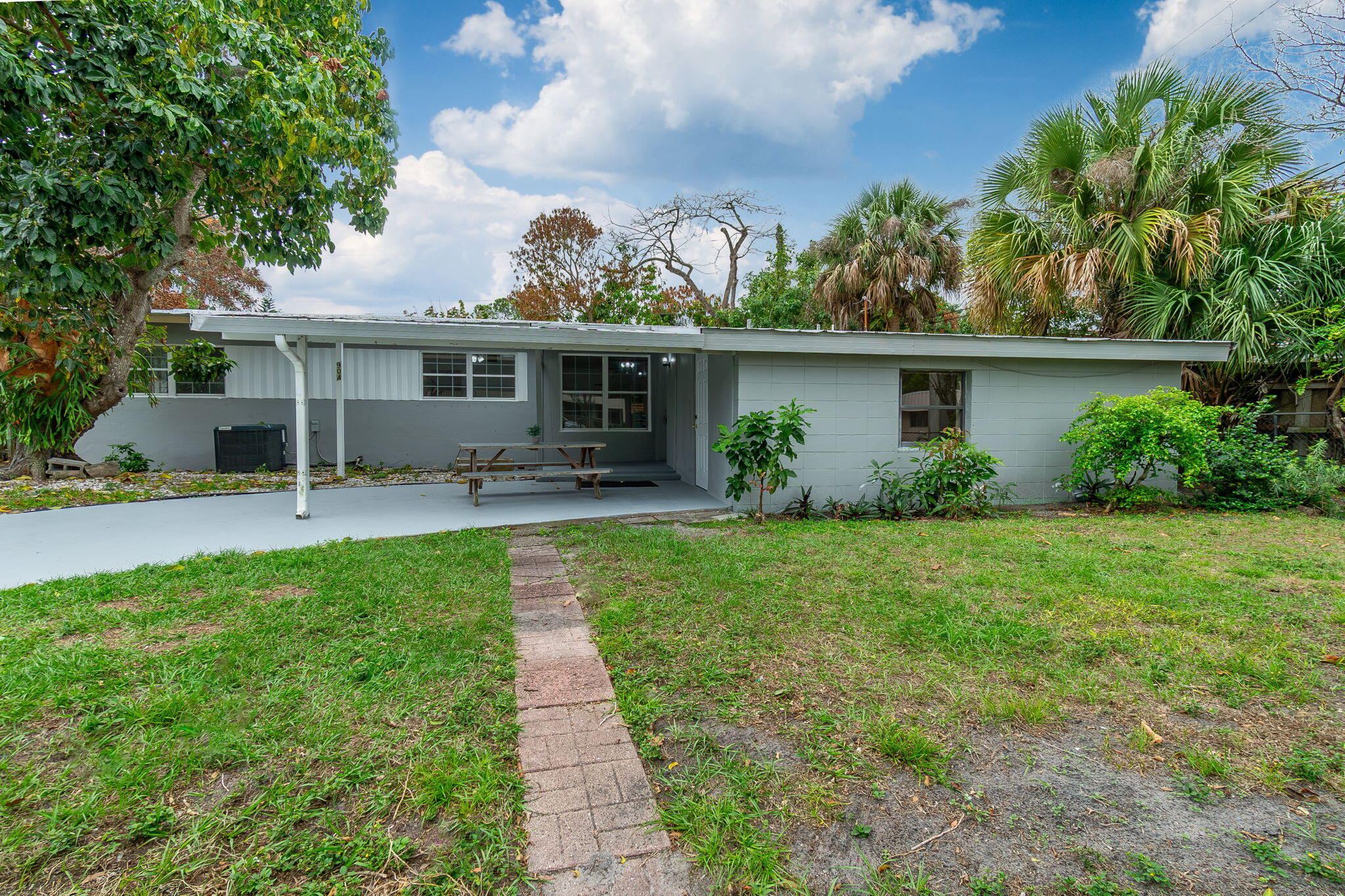 Spacious, light and bright 4 bedroom/2 bath single family home in the heart of Stuart. No HOA. Attractive Seller financing available. Located on a quiet street with fenced back yard, this lovely CBS home has 4 sizeable bedrooms plus a family room. A brand new metal roof installed June 2026. *City water and *city sewer. This home features neutral tile and new laminate floors throughout, *newer central HVAC, *fresh paint, *brand new refrigerator, new stove, new washer, new dryer and brand new hot water heater.  Large interior utility room. Bedroom 4 has additional separate entrance. Attractive SELLER FINANCING available. Come see this lovely home today! The new metal roof finsihed  June 5, 2026.  One exterior photo is AI generated and labeled as AI. The other exterior photos are actual (before the new roof).  No HOA. No leasing restrictions.