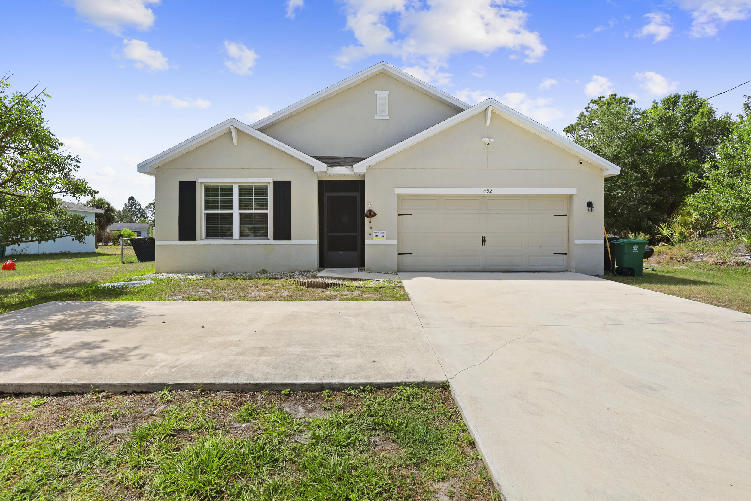 This Beautiful and functional designer home was build by D.R Horton in 2019 , This is a 4 Bedroom and 2 Bathroom , 2 Car Garage home on .23 Acres with a fully fenced back yard with plenty of room to build a pool . A spacious family room to expand to a casual dining area and an open Island kitchen for family .a great space to entertain lots of guests. Plenty of parking space . Home comes with impact windows and shuttles. Close to Turnpike and I-95   Shopping , and both Orlando and Palm beach Airports , Don’t miss this opportunity come see this beautiful.