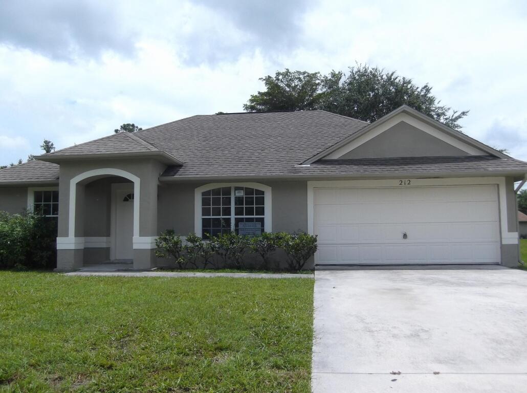 Charming 3-bedroom, 2-bath home with a 2-car garage featuring a desirable split-bedroom floor plan, vaulted ceilings, and ceramic tile throughout the main living areas. The spacious kitchen offers ample counter space, a pantry, and a pass-through to the dining area. Enjoy the large backyard with a fenced section and plenty of room for a pool. Conveniently located near shopping, dining, entertainment, schools, and major commuter routes in St. Lucie West.