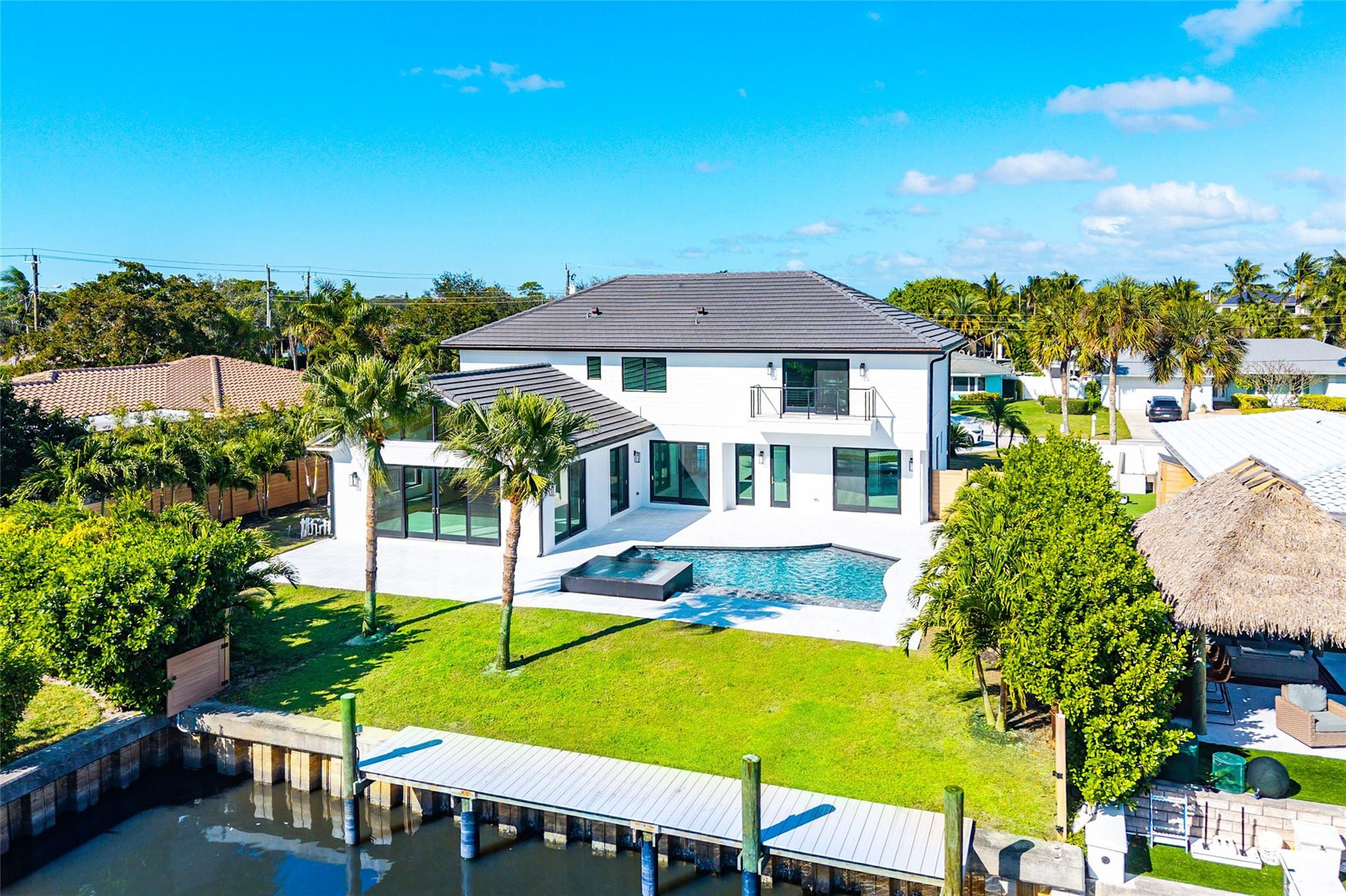 8 Leeward, a newly transformed waterfront jewel in the coveted Village of Tequesta. Designed in a modern coastal organic aesthetic, this 5 bed, 6 bath residence offers 60 feet of pristine waterfront with effortless ocean access. Interiors are curated by celebrity interior designer Vanessa Antonelli, showcasing custom millwork, floor to ceiling glass, artisan lighting, and rich marble finishes throughout. The chef’s kitchen features an oversized island, hidden walk-in pantry, professional-grade appliances, and striking natural stone. Every bedroom is en suite, providing exceptional privacy and comfort. The expansive primary suite serves as a serene retreat with spa-like finishes and tranquil water views delivering an elevated waterfront lifestyle in one of Tequestas most desirable enclaves.