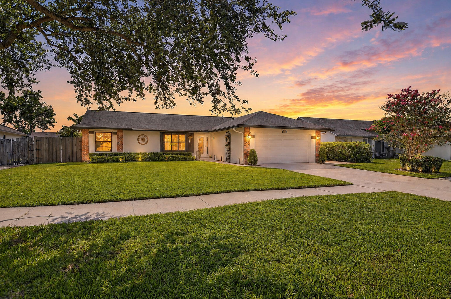 Beautifully REMODELED 3BR/2BA home shines w/ an open floor plan, sensational porcelain plank tile flooring, soaring 10' ceilings w/ LED lighting, + surround sound. UPDATED kitchen features Samsung S/S appliances, custom soft-close beadboard cabinetry, granite countertops, farmhouse sink, and coffee bar with gorgeous porcelain backsplash. Fall in love in your primary suite boasting custom closet & UPDATED bath w/ frameless shower. Guest bedroom includes Murphy bed. Guest bath has a counter height vanity w/ undermount sink!  IMPACT windows & doors,  NEW Samsung W/D, Entertain like a rock star with guests on your HUGE screened patio w/ east exposure, or sip a cool drink in the hot tub. Relax on the fenced paver deck w/ a firepit, BBQ station & double gate for boat storage. NEW ROOF! Low HOA!