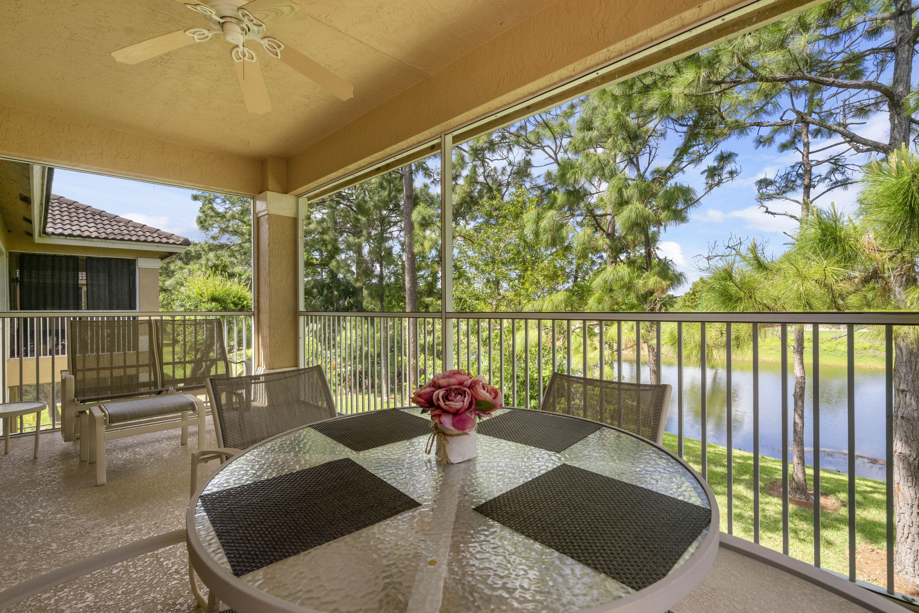 WHAT A VIEW! This meticulously maintained 2BR/2.5BA condo offered fully furnished/turnkey in Castle Pines boasts serene lake and golf views with a treehouse feel! Perfect as a seasonal residence, full time home or for an investor wanting to have rental income! Some of the many special features include county only taxes, granite counters throughout, upgraded stainless steel appliances in the kitchen, tray ceilings and tile through the main living areas. Kitchen with breakfast bar for extra seating is open to the living area. The main bedroom is spacious, includes an ensuite and walk-in closet. Convenient half bath off of the hall is great for entertaining.  The lock-off door between the main side of the condo and the studio side includes kitchenette, full bathroom plus private entrance door -providing the opportunity to use one side of the condo, while renting the other, rent both sides or use the whole condo for yourself. There is a private washer/dryer too! Screened and covered patio is the perfect place to sit and enjoy the view. Condo association will soon be replacing all roofs with standing-seam metal roofs and repainting the buildings, for a fresh Florida feel! HOA dues include cable, internet, water, sewer, building insurance, roof, lawn care, landscaping, resort style pool and access to the Island Club. PGA Village is an amenity rich community with COUNTY ONLY TAXES surrounded by multiple golf courses where membership is optional. Enjoy NY Mets spring training game, golf courses, beaches, shopping, dining and neighboring coastal towns. Call today to view!