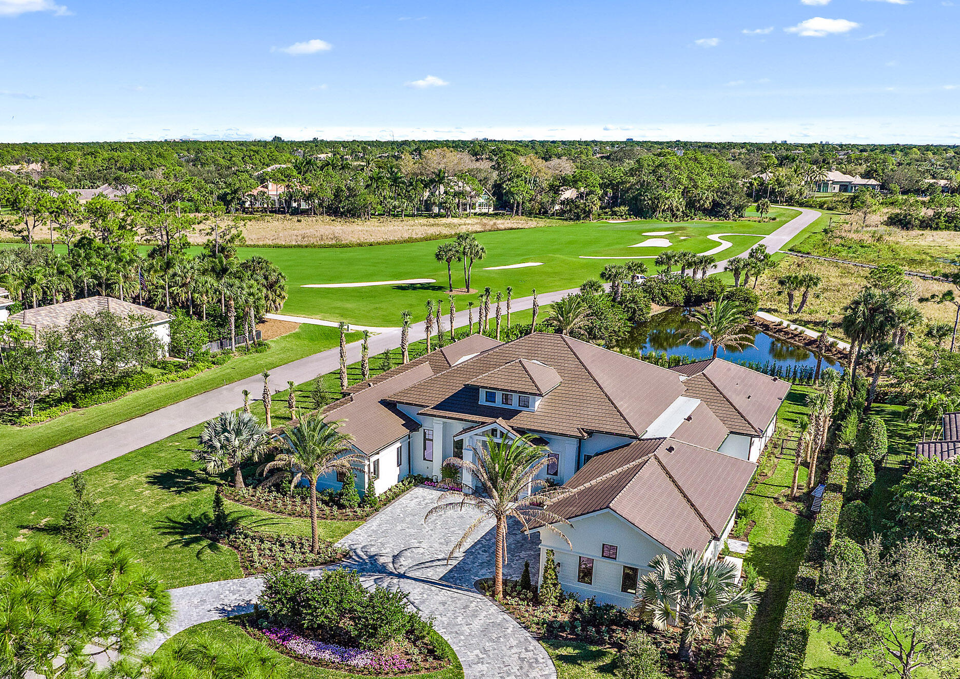 Exquisite New Construction - 4BR/5.2BA with office/den and dual master baths on an over-sized corner lot with expansive views, located in luxurious Old Marsh Golf Club.  Light and bright transitional decor with every detail imaginable: Custom 14' mahogany entry door, custom 14' sliding glass doors overlooking the pool/spa, wide-planked European white oak hardwood flooring, wine room with full wet-bar. Dream kitchen with Sub-Zero and Wolf, outdoor living with fireplace and electronic screens, summer kitchen, 3-car garage with high ceilings and doors to accommodate lifts for the car enthusiast...NO detail overlooked! A must see property, nestled within one of the finest gated golf communities in Palm Beach County. No tee times and minutes to 5-star dining, beaches and Palm Beach shopping. Old Marsh is nestled between Donald Ross Road and PGA Blvd.  No tee times, caddies and and an unparalleled level of service highlight this Emerald Award-Winning Club. Developed around the Pete Dye Championship Design, Old Marsh is an intimate and refined club limited to 275 members and 185 homes. All just 18 miles from Palm Beach International Airport.