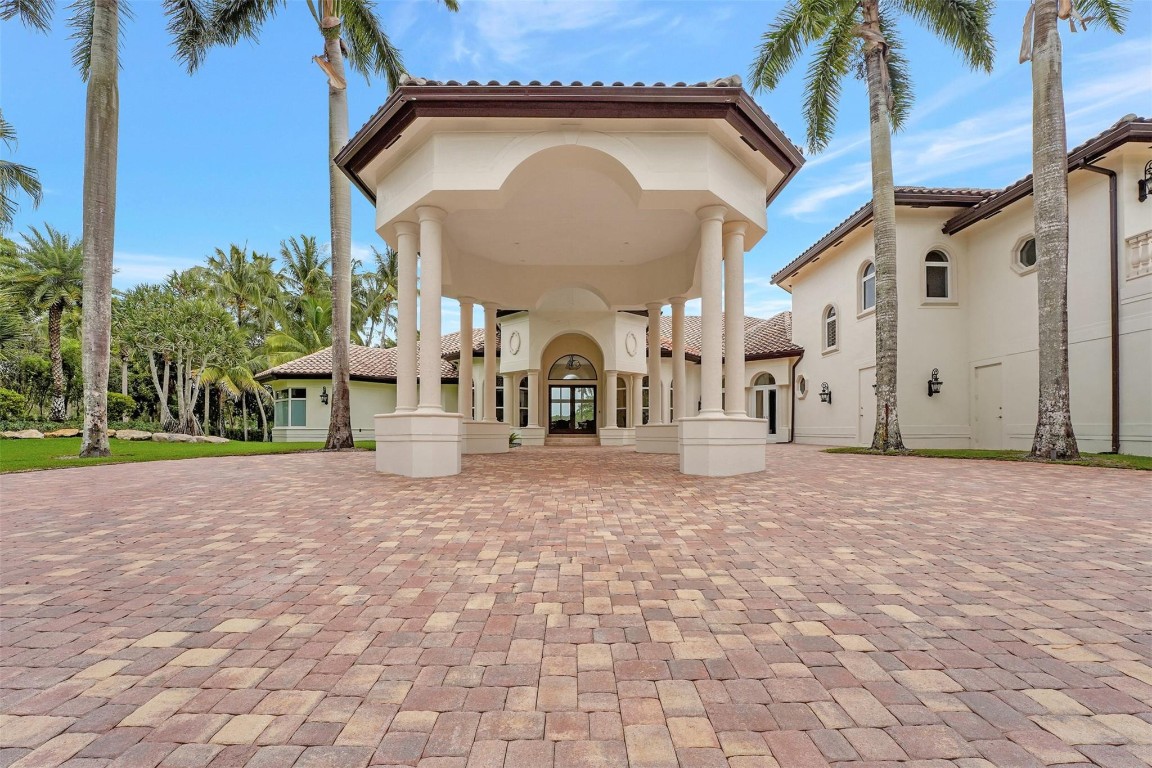 Exquisite luxury home within prestigious Windmill Ranch Estates. Grand entrance into the beautifully detailed & recently completed 7-figure remodel inside and out, w/ expansive lake views, lush landscaping, resort pool, & mature palm trees adorn this property. Unique masterpiece has fine craftsmanship, exquisite finishes, high volume ceilings, Jerusalem Stone, real wood floors, private office, outfitted bar, & formal dining. Gourmet kitchen, granite tops, custom cabinetry, massive center island & breakfast area. Lavish primary suite with large walk-in closets & resort style master bath w/ oversized Jacuzzi Tub, dual showers with full Steam. Cabana bath w/spa sauna & shower. Fully equipped Summer kitchen gazebo seats 20+. Oversized 3 car garage with marble floors, & expansive driveway.  Current owner under contract for new roof.